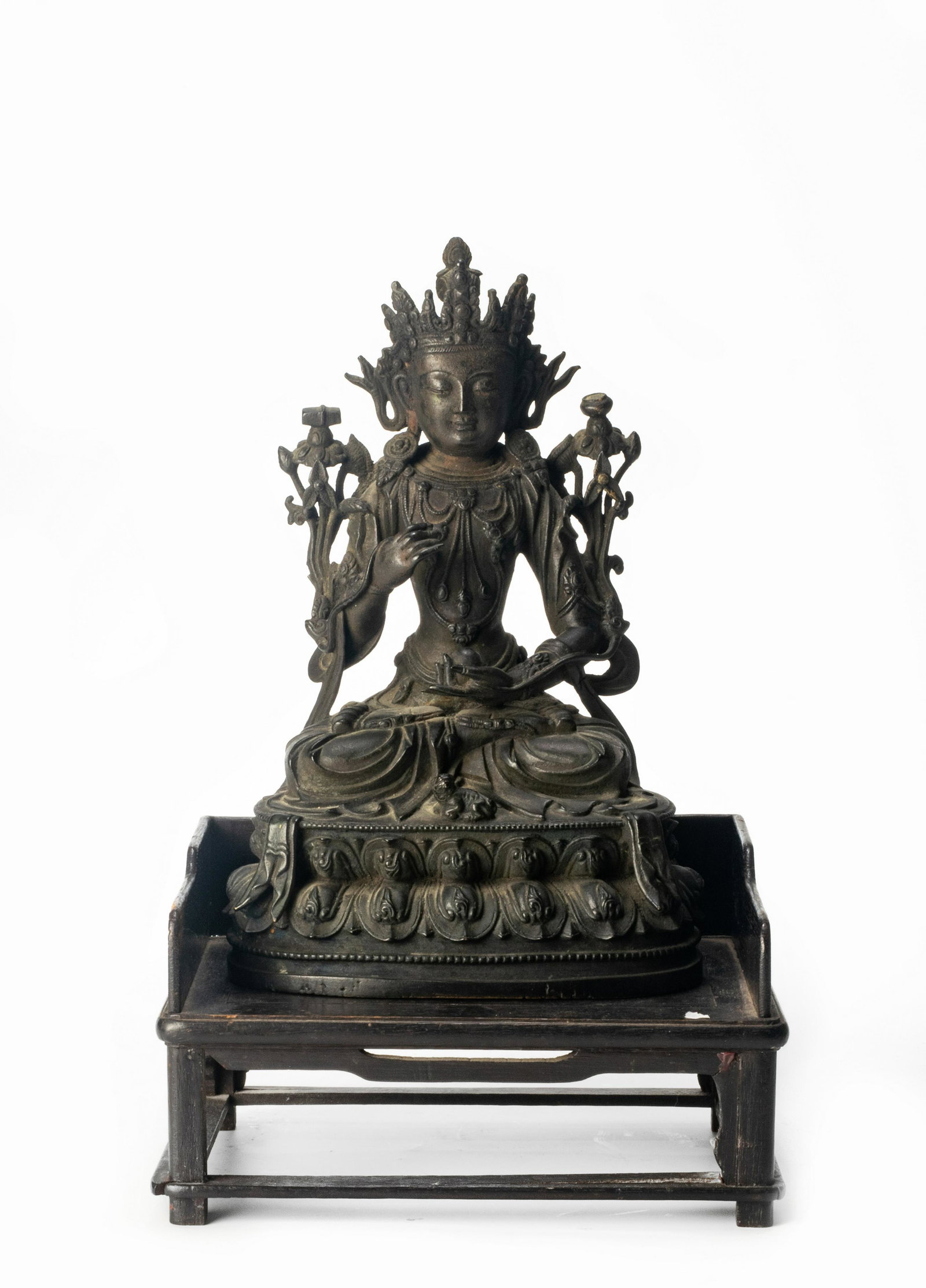 Chinese Bronze Buddha with Wood Base, Ming Dynasty: A Chinese bronze seated Buddha with a wooden stand dating from the Ming dynasty. The Buddha makes a blessing gesture in 1 hand and holds a ball of immortality-granting herbs in the other. There is a t
