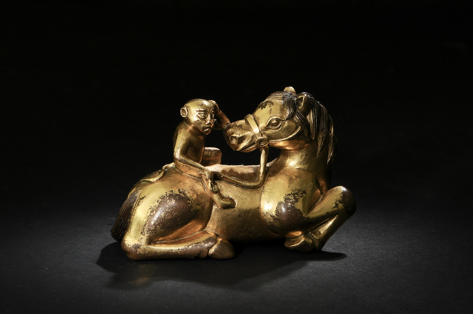 Gilt Bronze Statue of Monkey on a Horse, Ming: 明代 銅鎏金馬上封候 A Chinese gilt bronze figurine of a monkey on a horse dating from the Ming dynasty. Dimensions are: 2 inches tall X 2 1/2 inch