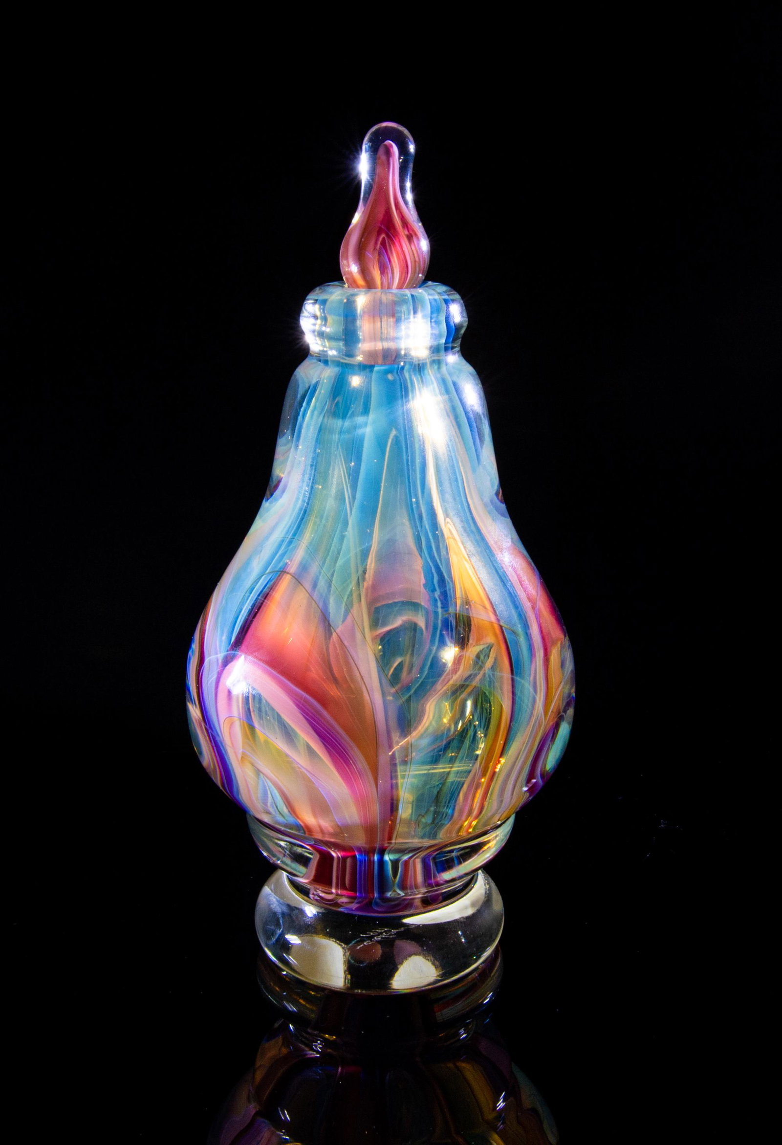 Charles Wright Studio Glass Bottle with Stopper: Charles Wright studion glass bottle with stopper. Large, art glass perfume bottle with rose, amber, and opalescent white suspended in clear glass. Signed -CWright 1979 on base. Dimensions are: 3 1/2 i