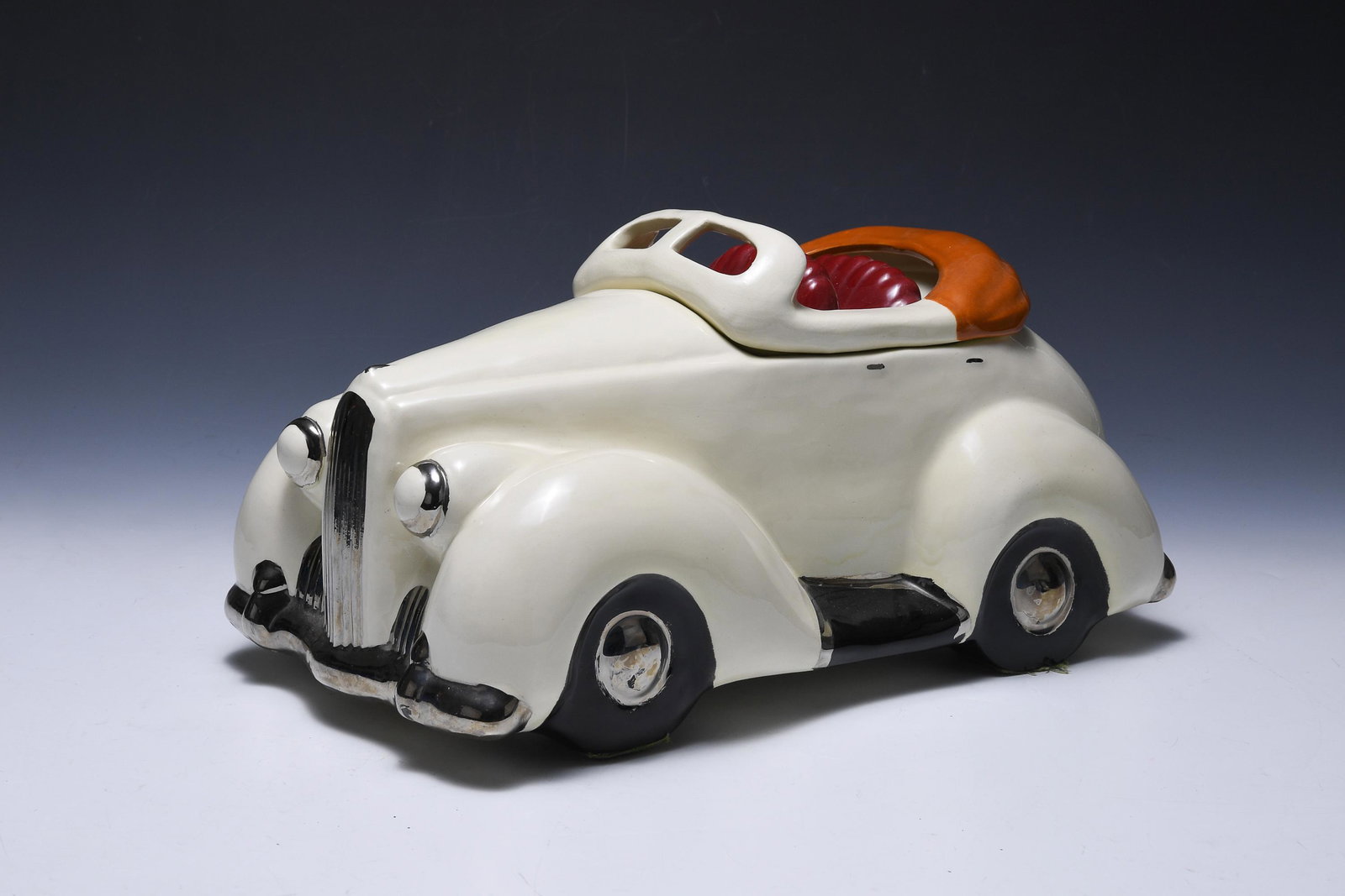 Glenn Appleman Packard Convertible Cookie Jar: Glenn Appleman (American, 20th century) Packard convertible ceramic cookie jar with a white exterior, silver trim, and a red interior. Signed on base Appleman 1979. Dimensions are: 14 5/8 inches long 