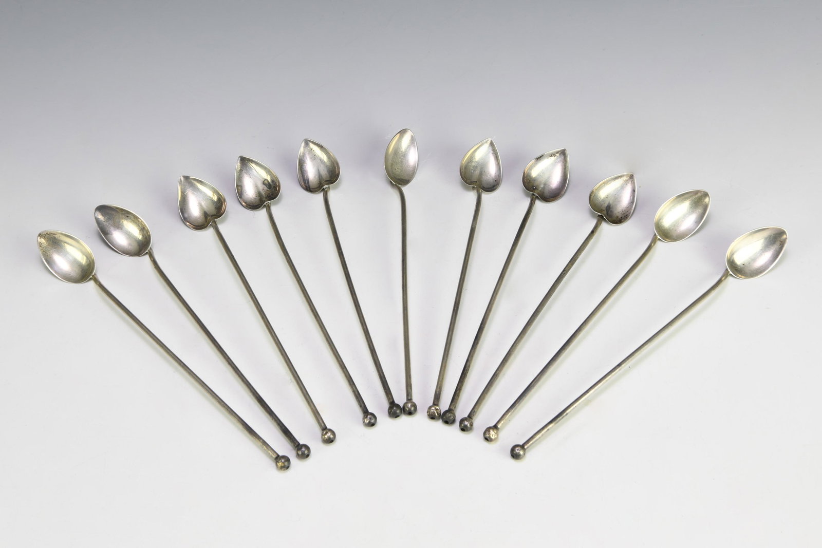 (11) Sterling Silver Spoon Straws: (11) sterling silver spoon straws: 5) with oval bowls and (6) with heart-shaped bowls, all stamped "STERLING." Total weight: 138 g (4.43 troy oz). Dimensions are: each spoon - 7 3/4 inches long X 1inc