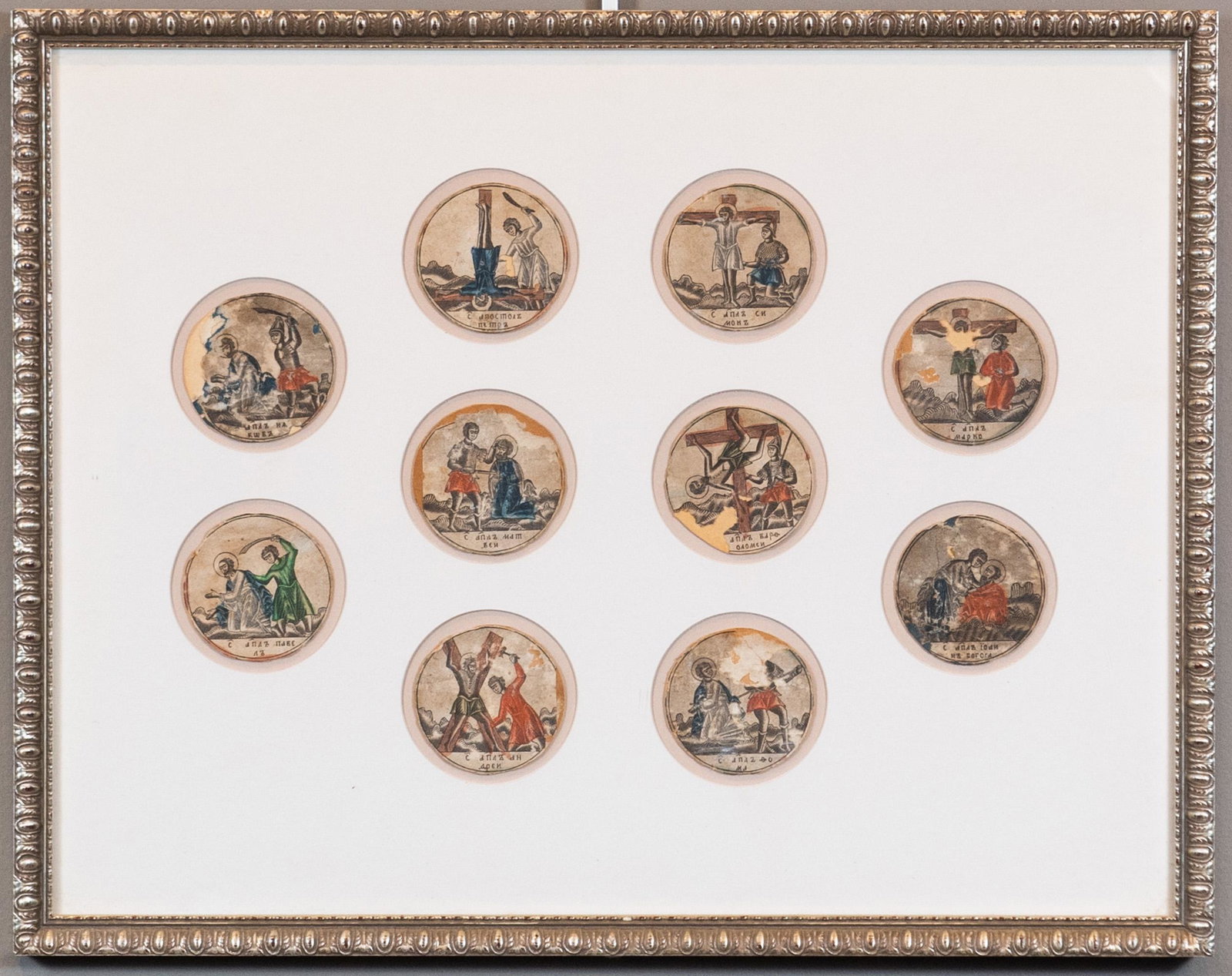 (10) Miniature Martyrdoms of the Disciples: (10) miniature scenes of the martyrdoms of the disciples, ink on pasteboard, Russian, 15th-16th century. Individual round discs, mounted together in a mat with circular cut-outs. Each disc includes a 