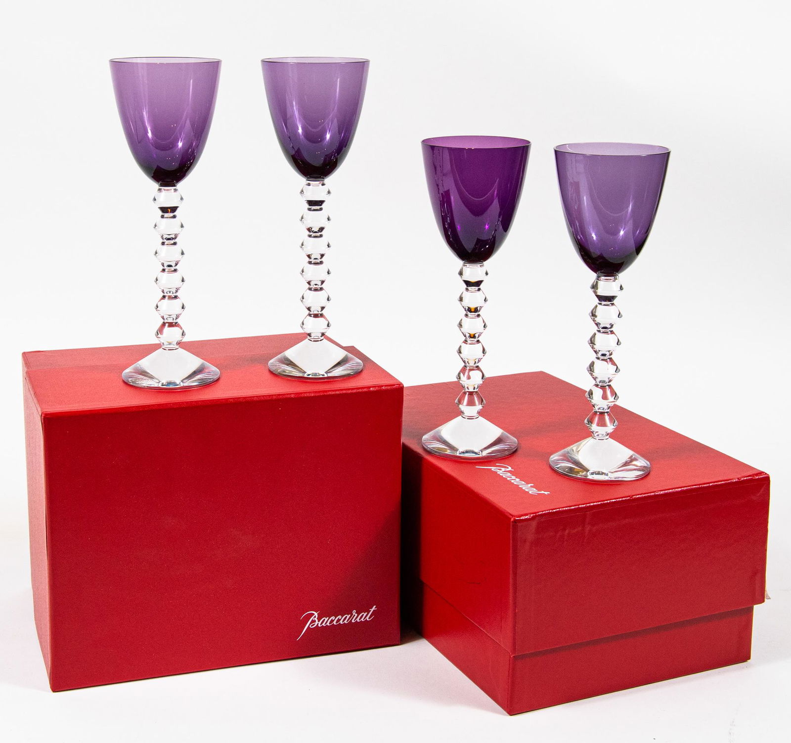 (4) Boxed Baccarat Vega Wine Glasses - Purple Bowl: Set of (4) Baccarat crystal Vega wine classes, with piled berlingot carton-shaped stems and purple colored bowls, French, 20-21st century. Reverse engraved Baccarat France mark on base. Glasses come i