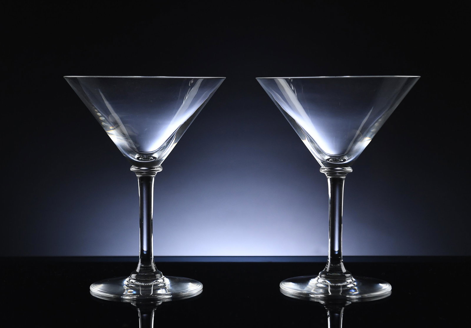 Boxed Pair Baccarat Martini Glasses: Boxed pair of clear Baccarat martini glasses. Stamped on base Baccarat France and signed Baccarat on base. Dimensions are: 6 inches tall X 4 1/2 inches diameter. All measurements are approximate. Cond