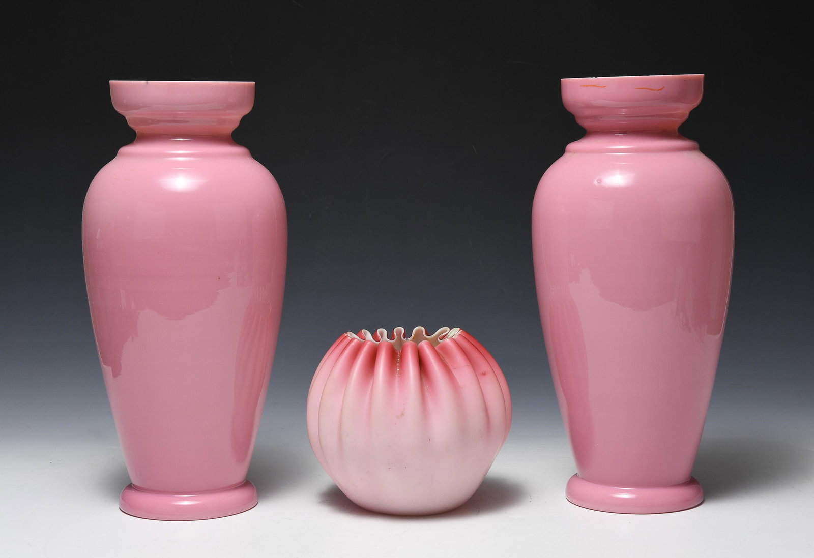 (3) Victorian Cased Vases: (3) Victorian cased vases. Smaller free blown example with pontil mark possibly by Thos. Webb. Includes two matching pink vases. Dimensions are: largest - 12 3/4 inches tall X 5 1/8 inches diameter. A