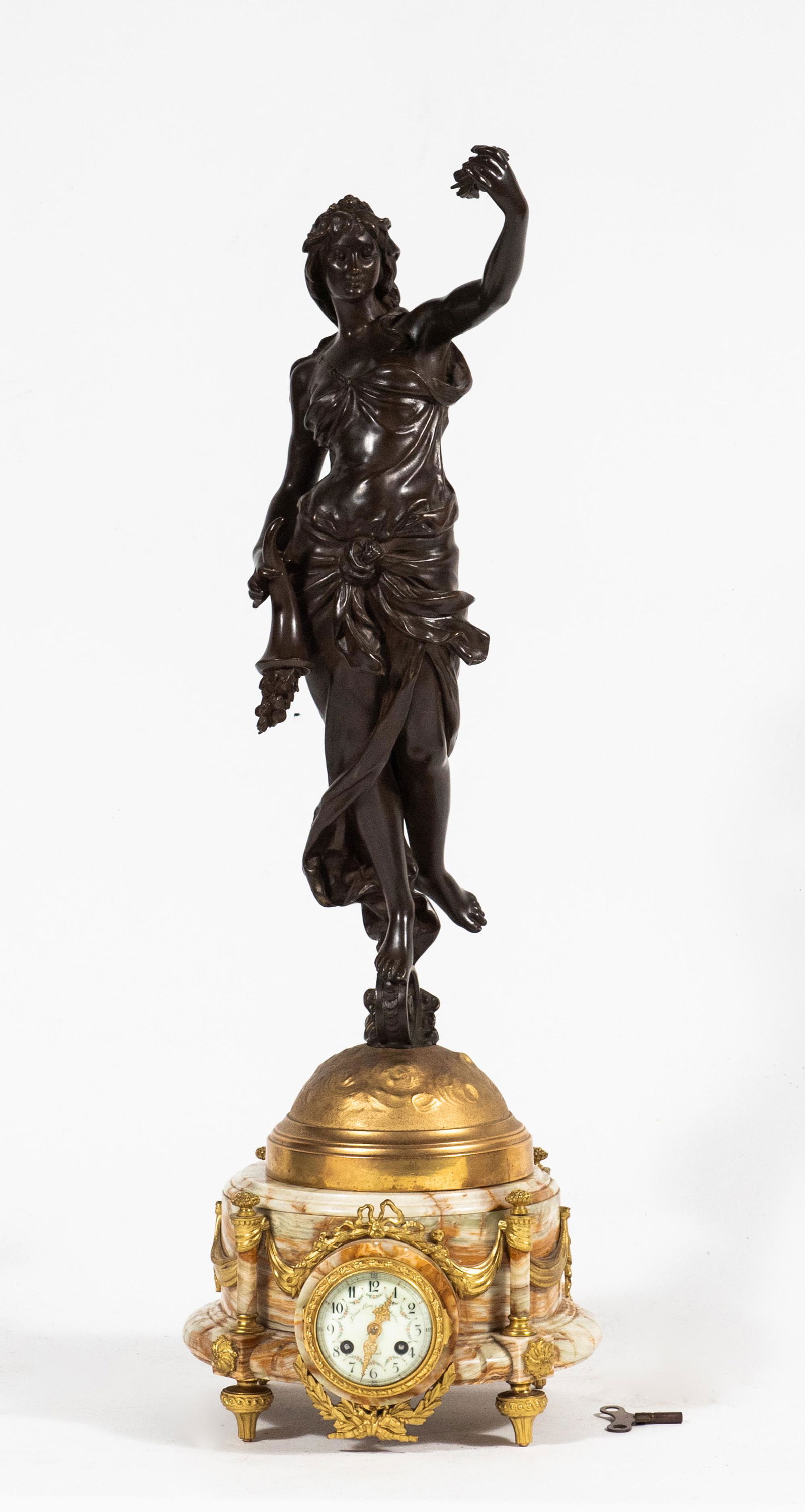 French Ormolu Clock w/ Bronze Figure of Fortuna: French ormolu clock with bronze figure of Fortuna. Round verigated onyx base is raised upon four ormolu feet extending into onyx columns topped with ormolu decoration. The glass face of the clock open