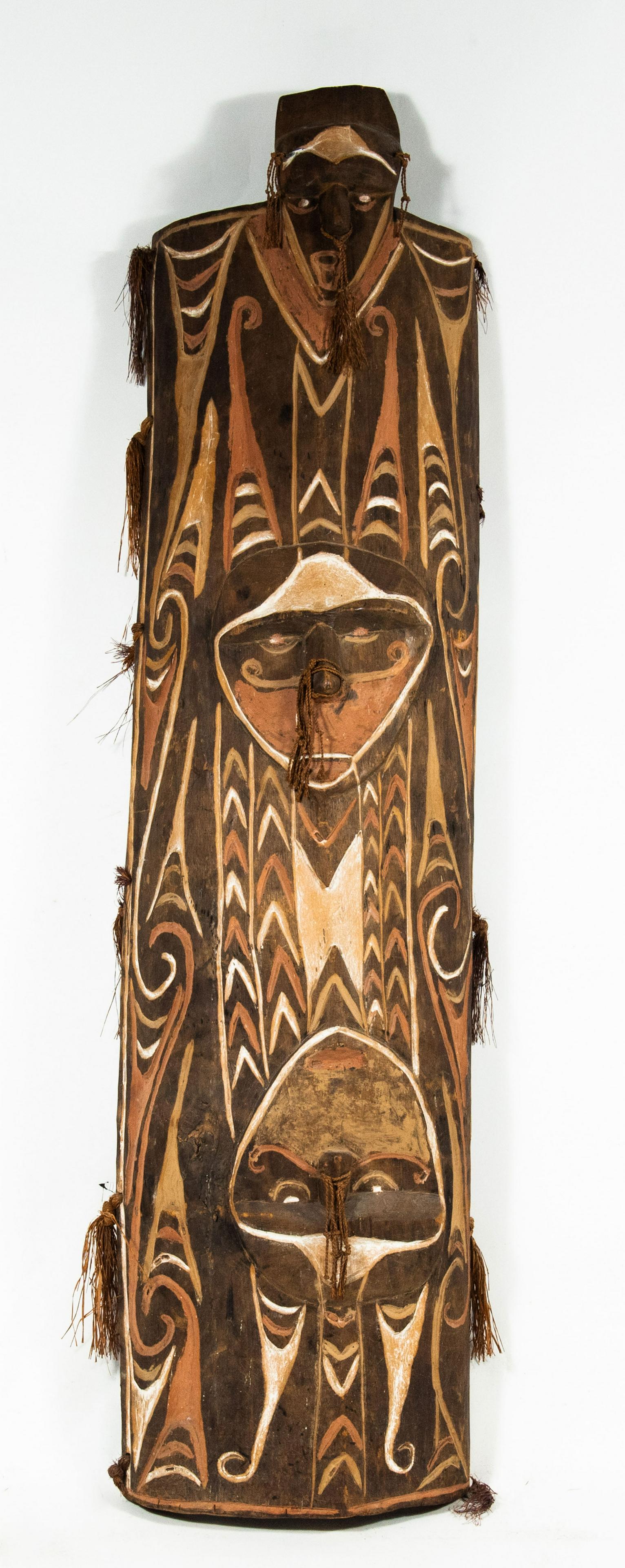 Large African Papua New Guinea Carved Shield: African New Guinea carved shield, 20th century, carved and polychrome. The shield is from the Vanimo-Green River District in Papua New Guinea and likely from the Biake Village. Includes a copy of the 