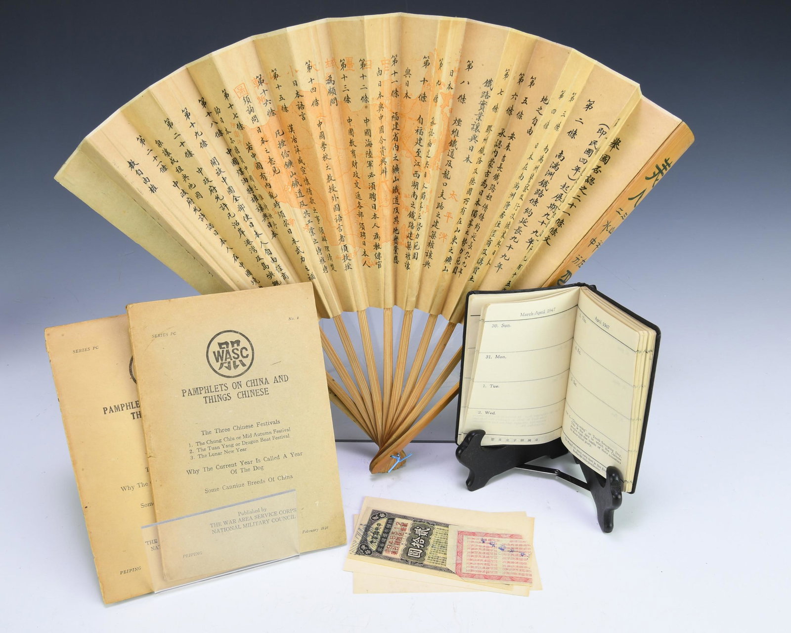 (5) Items Related to WWII Period China: Group of (5) items related to WWII-period China. Includes: One and a half pieces of paper currency; 1947 Omea China diary; two Pamphlets on China and Chinese Things; a paper fan decorated with a map o