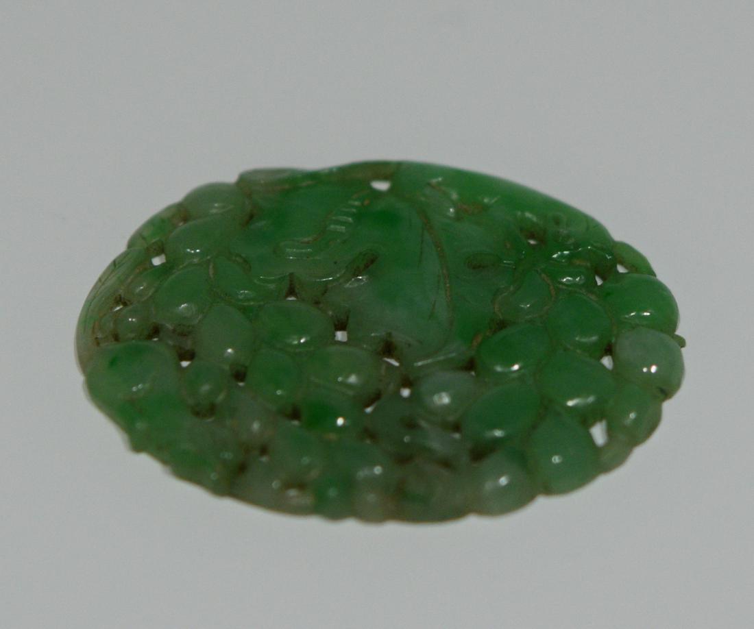 Carved Jadeite Oval Plaque, 20th Century: Carved jadeite oval plaque, 20th Century. Dimensions are: 1.5 inches long X 1.125 inches wide: 4 cm long X 3 cm wide. All measurements are approximate. Condition: No noted damage. Provenance: From a C