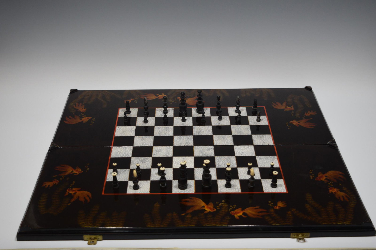 Japanese Lacquer Game Set - Backgammon & Chess: Japanese Lacquer Game Set - Backgammon & Chess. Hinged two piece board with chess board on exterior with backgammon on interior. Board has swimming Goldfish motif with with aquatic vegetation. Dimensi