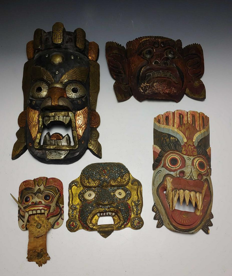 (5) Southeast-Asian Wood, Brass & Enamel Masks: (5) Southeast-Asian wood, brass & enamel masks: a) Balinese carved wooden mask of protective demon with blue face, gaping tooth-filled mouth, snout nose and elaborate vertical headdress in blues, pink
