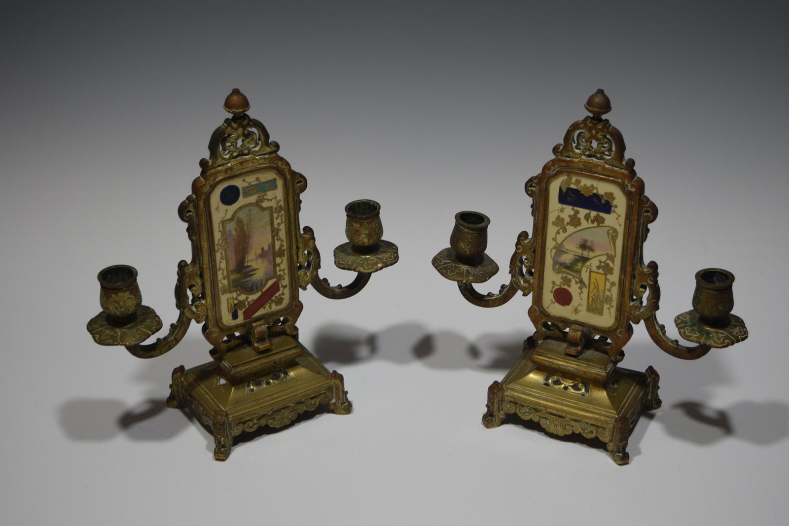 (2) Ormolu Nautical Candelabra, French Aesthetic: Pair of ormolu candelabra (candlesticks) with ceramic plaques of water and nautical scenes surrounded by chinoiserie gilt foliage and sea flora and fauna, French, Aesthetic Movement (late 19th century