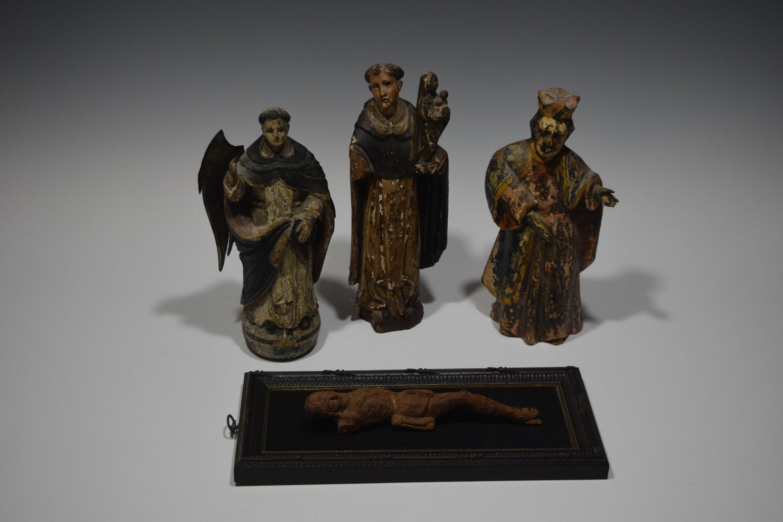 (4) Antique Spanish Wooden Saints & Crucifix: (4) antique Spanish carved wooden saints and a crucifix, includes: a) wooden carved and painted figure in Dominican habit, with metal wings painted silver, holding a book in his left hand and raising 
