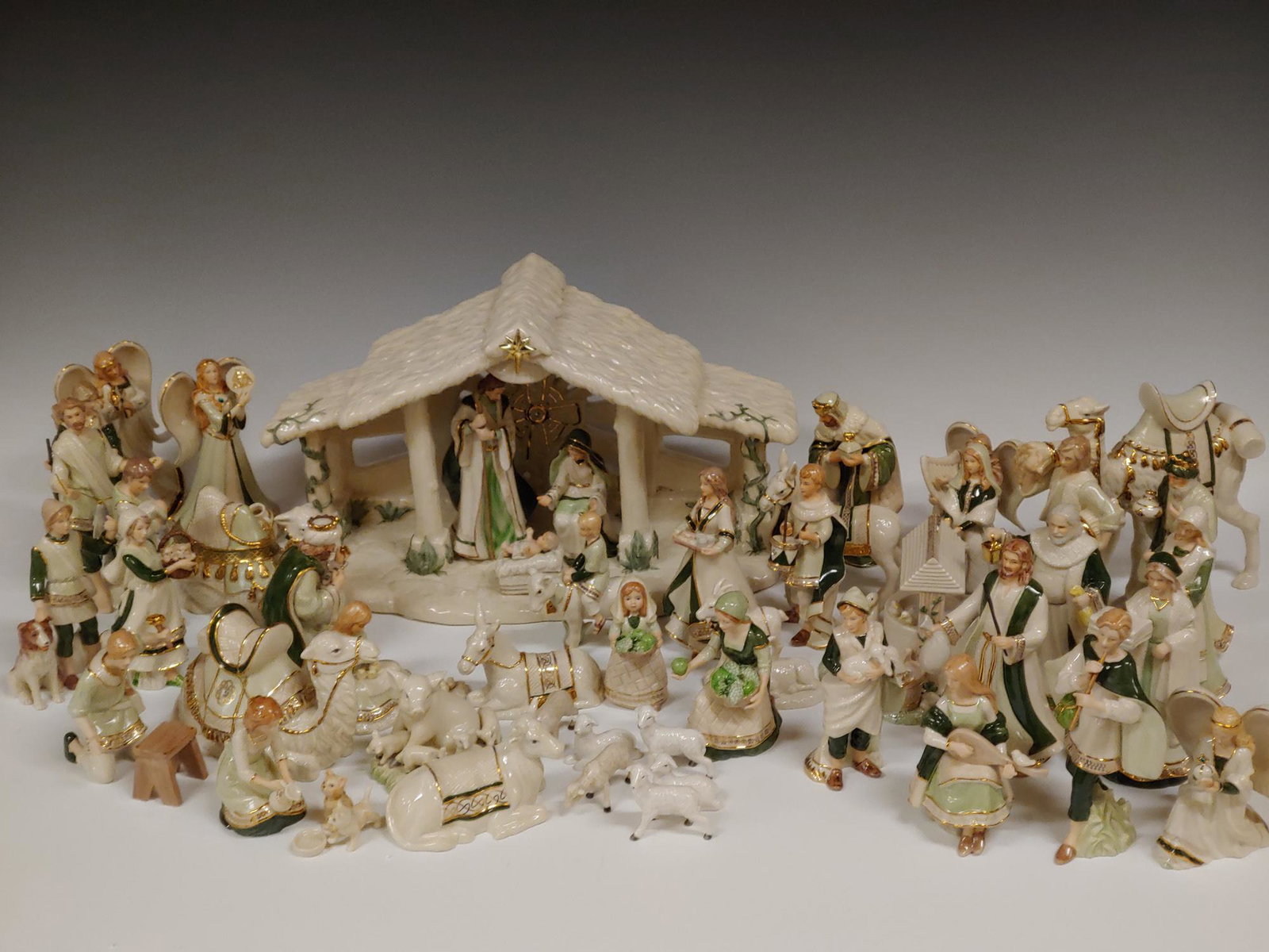 (21) Porcelain Hawthorne Village Irish Nativity: (21) piece Hawthorne Village Irish Nativity porcelain set in original styrofoam protectors, each with certificate. Set is decorated in greens and gold trim on most items. Dimensions are: Stable: 8.5 i