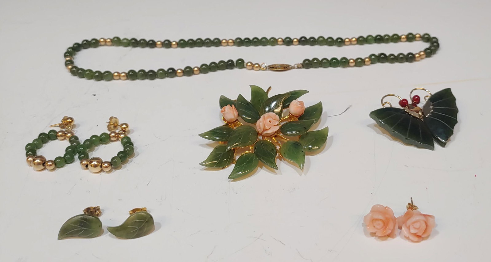 (9) Jadeite & Coral Brooches, Earrings & Necklace: (9) jadeite & coral brooches, earrings & necklace: Earrings with 14K Gold posts. Dimensions are: necklace - 8 inches long. All measurements are approximate. Condition: No noted damage. Provenance: Fro
