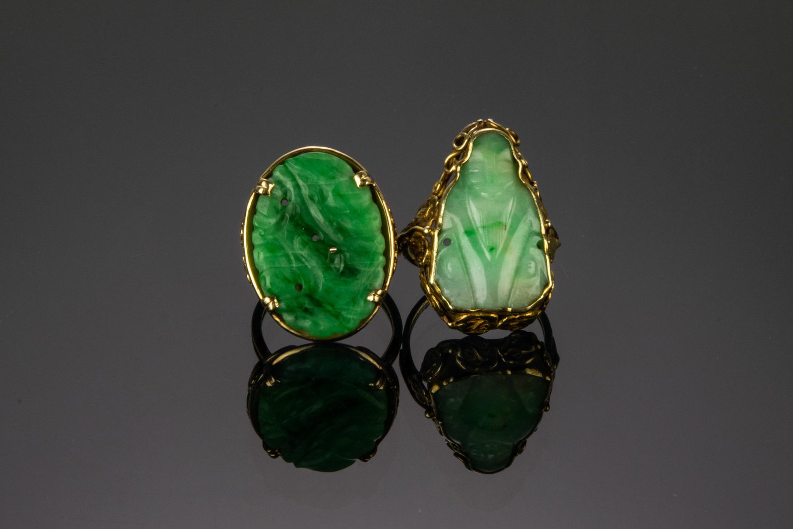 (2) 14K Gold Rings Carved Jade Panel, Ming's: (2) 14K gold rings with carved jade panels: a) Ming's Hawaii, 14K Gold Ring Carved Jade Panel. Impressed, "MINGS 14K" on inside of shank, ring size 8. Weight: 7.85 g, (0.252 troy oz). b) Custom 14K go