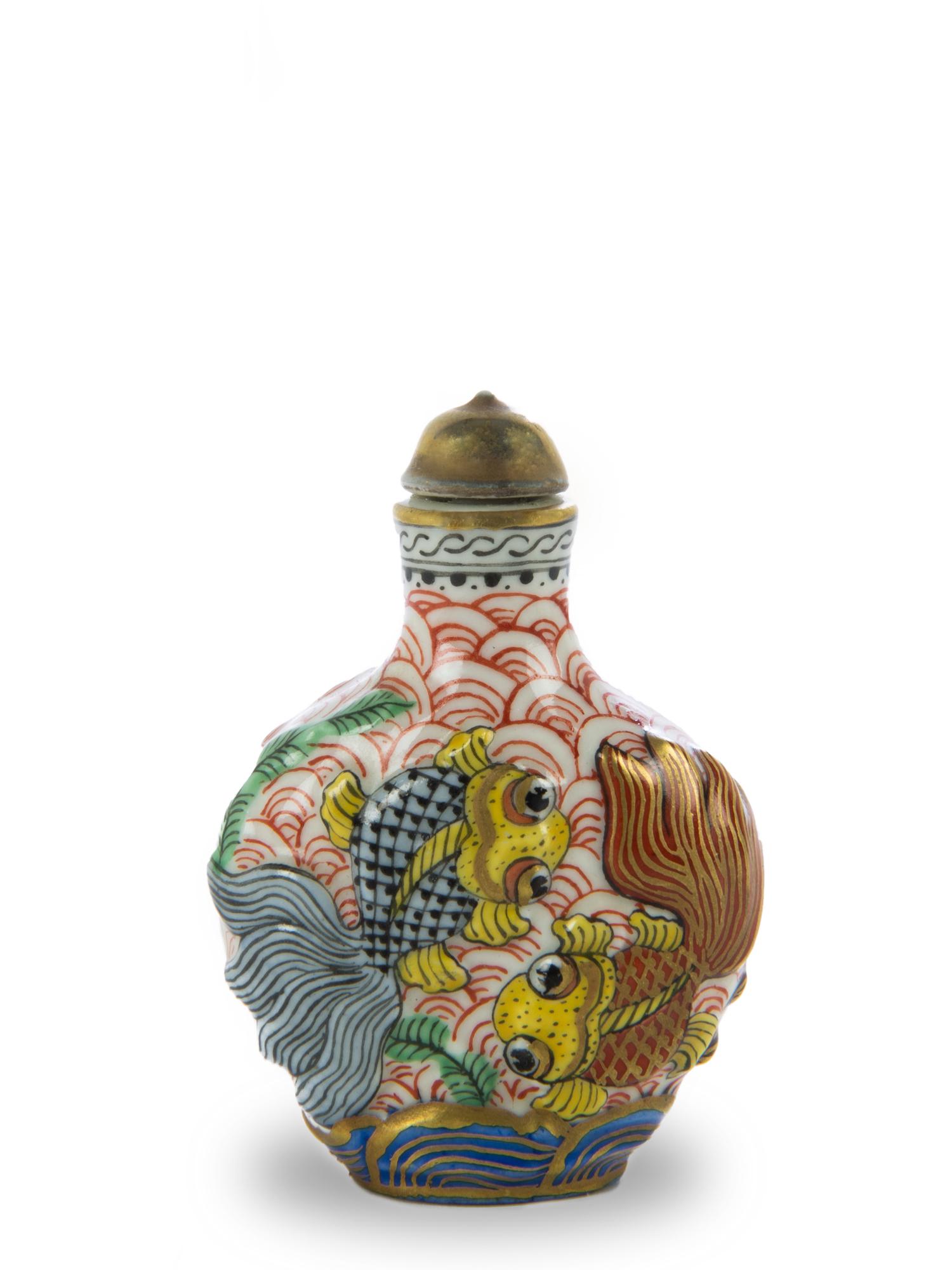 Famille Rose Goldfish Snuff Bottle, Early 20th Century: A Chinese famille rose porcelain snuff bottle featuring goldfish and dating from the early 20th century. The front features a brown goldfish and lotus in low relief on the front and 2 goldfish in blac