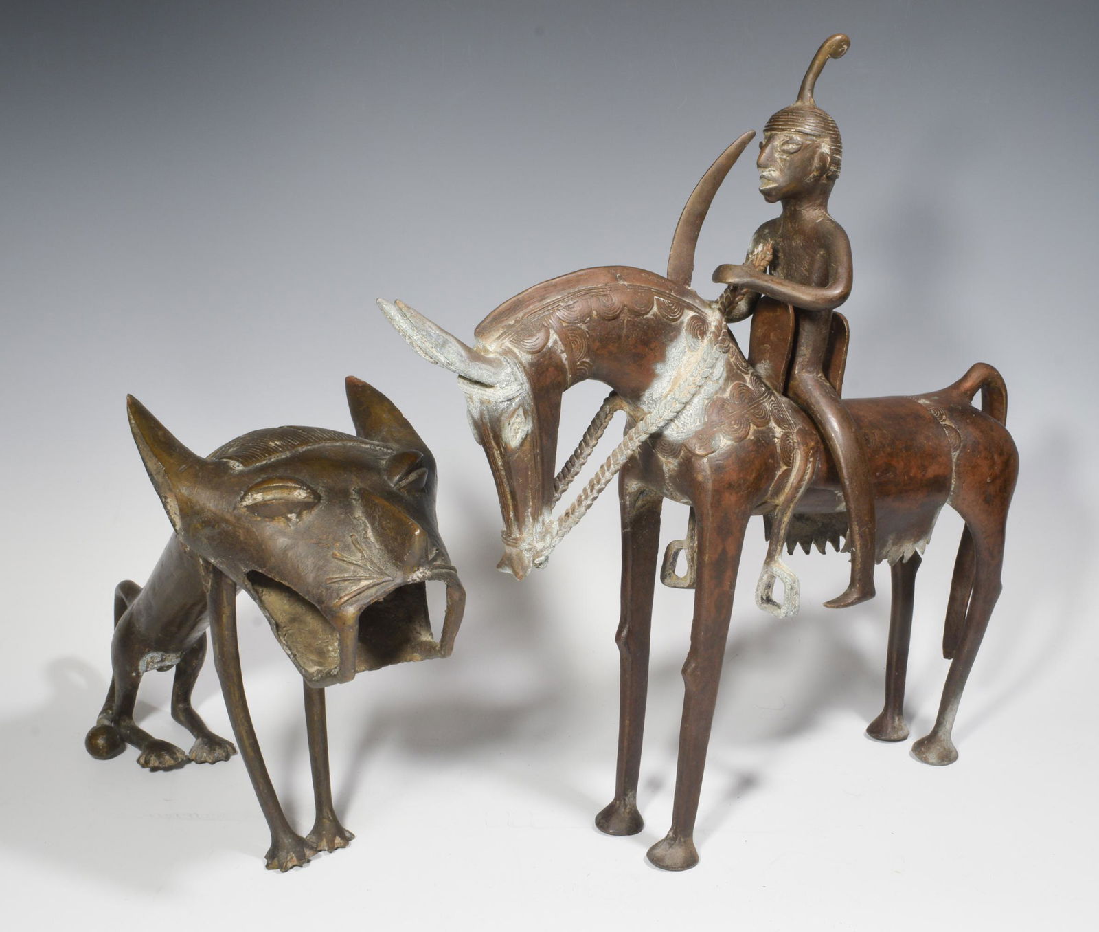 (2)African Benin Style Figure Mounted Rider & Lion: (2) African Benin style figure mounted rider & lion. Rider has traditional headdress and carries sword. Horse has saddle, stirrups, reins and armor. Lion is in sitting position with ball at end of tai