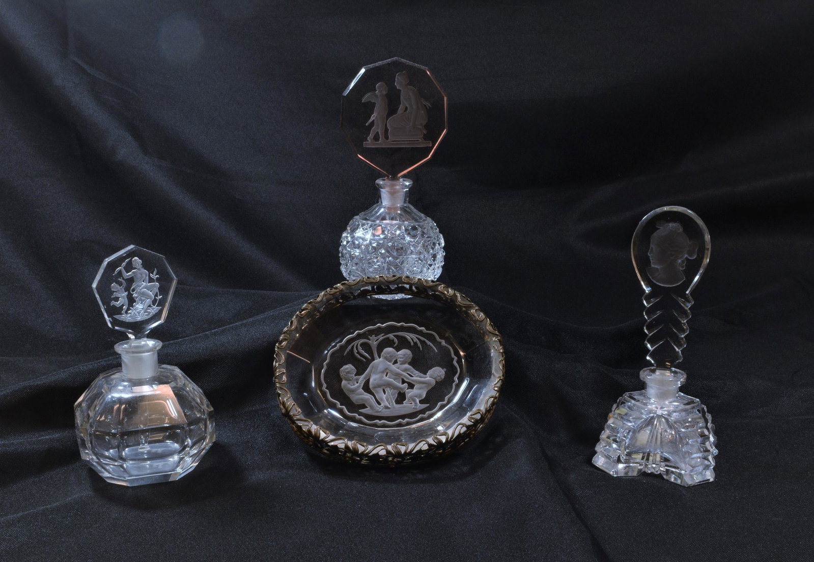 (4) Czech Perfume Bottles Intaglio Stopper & Tray: (4) Czech perfume bottle intaglio stopper and tray. Three clear perfume bottles marked 'Made in Czechoslovakia' on bottom. a) bottle is in an X shape, stopper shows the profile of a woman; b) circular