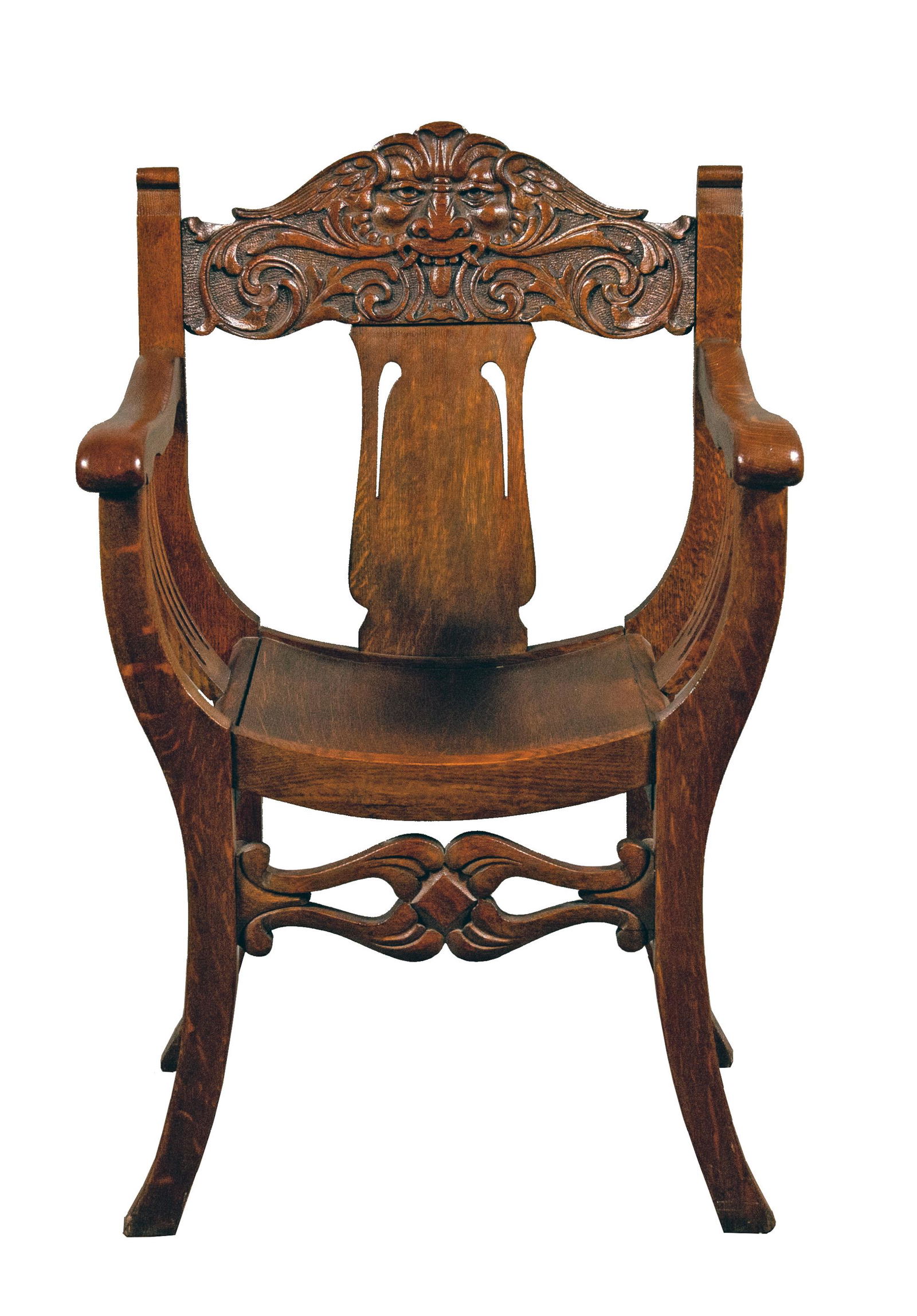 Carved Oak Savonarola Chair: Carved oak Savanarola-style chair, with curved seat and sides and the top rail carved with grotesque winged face and volutes. Carved legs and stretchers; the stretchers are squared, rather than splaye