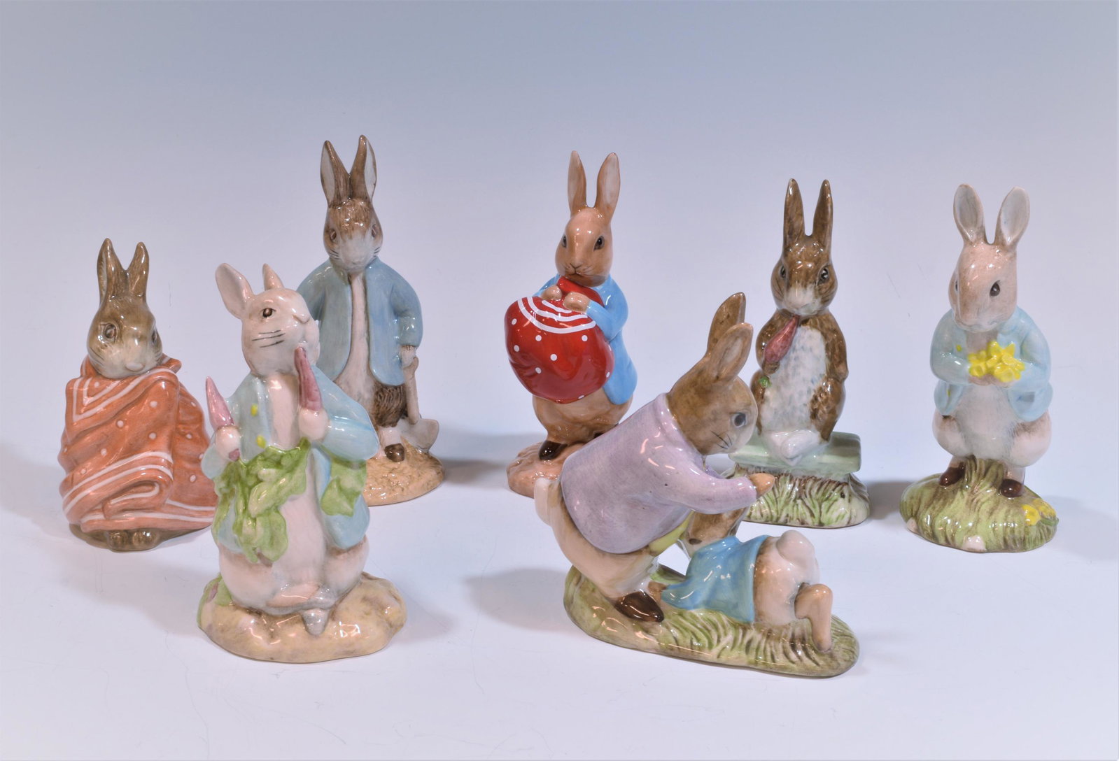 (7) Beswick, Coalport & Royal Albert Peter Rabbits: (7) Beswick, Coalport & Royal Albert Peter Rabbits, Beatrix Potter figurines. "Peter Rabbit Digging," "Peter ate a Radish," "Fierce Bad Rabbit," "Poorly Peter Rabbit," "Peter with Daffodils," "Mr Benj