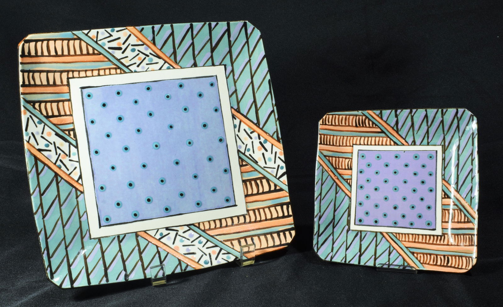 (2) Dorothy Hafner Dinner & Salad Plate: (2) Dorothy Hafner dinner and salad plate: square plates decorated in a similar geometric pattern with blue/greens, purple, and orange. Both are signed on bottom with "Hafner c 1980." Dimensions are: