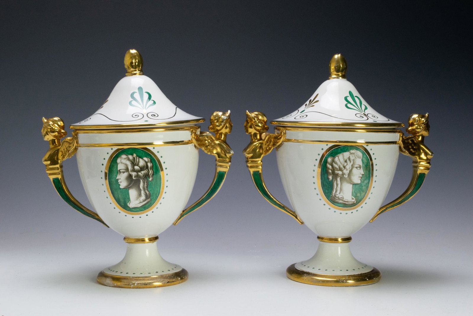 (2) Zaccagnini Fruit Coolers With Gilt Handles: Pair of Zaccagnini fruit coolers with gilt handles. Each is decorated with cameo painting of a woman's head. Handles are in the form of a winged woman's bust. Signed on bottom of each: Italy 1496/ 589