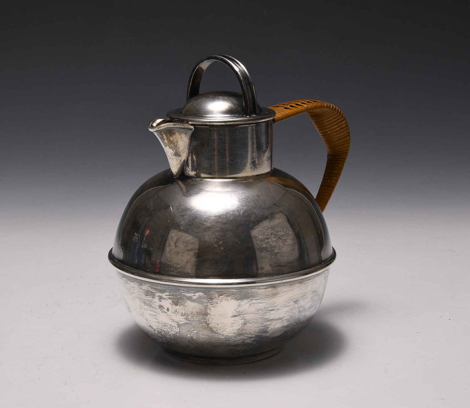 Art Deco Silverplate Teapot EG Webster & Son: Art Deco silver-plate teapot by EG Webster & Son (New York, 1886-1928). Bulbous form with original wicker handle. Weight: 16 troy oz. (497.3 grams). Dimensions are: 5 3/8 inches (13.7 cm) wide with ha