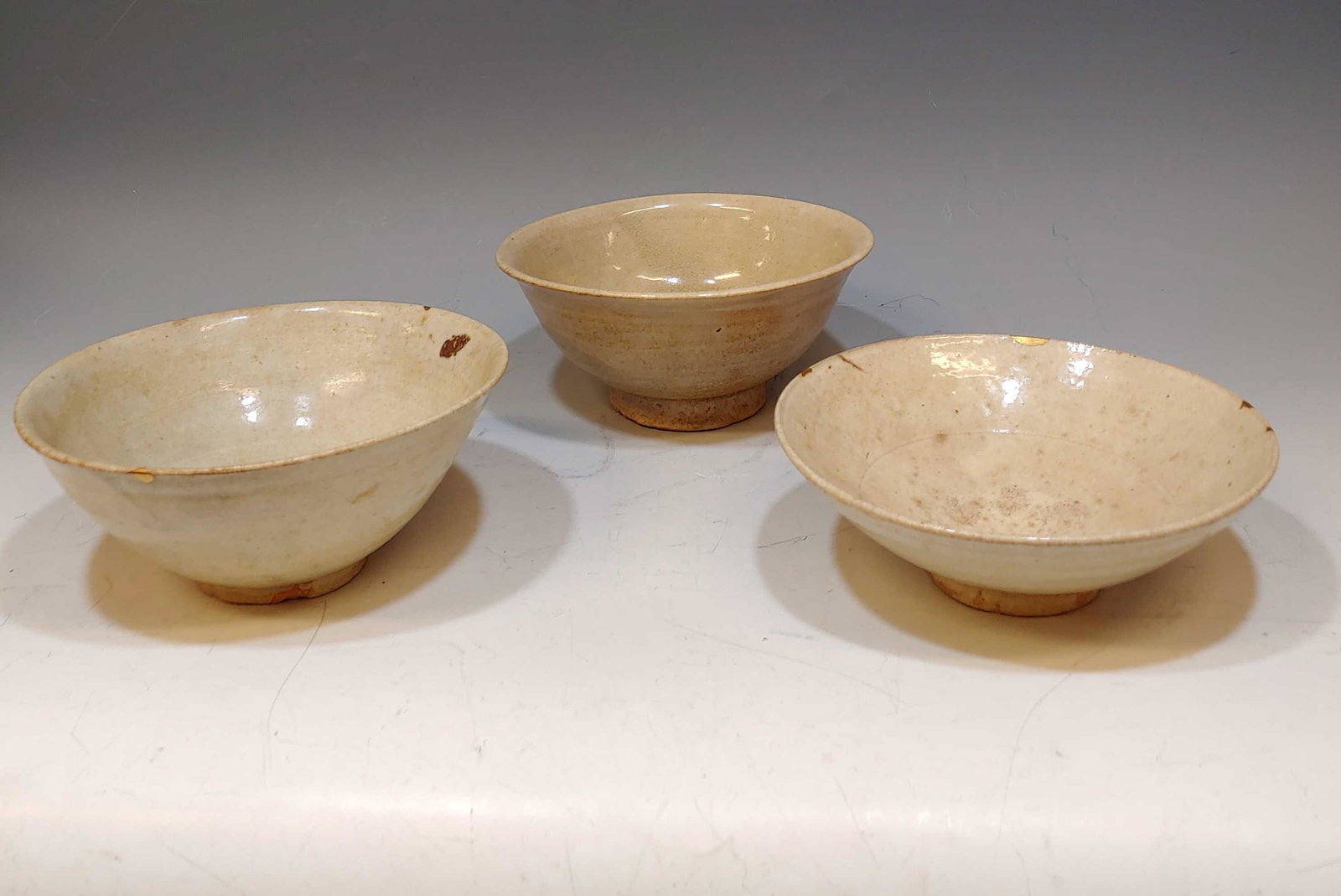 (3) 16th Century Korean Glazed Bowls: (3) 16th century Korean glazed bowls. Two have Kintsugi repairs to rim and all have a crackle glaze. Dimensions are: largest: 3 1/8 inches (7.9 cm) tall X 7 1/4 inches (18.4 cm) diameter. All measurem