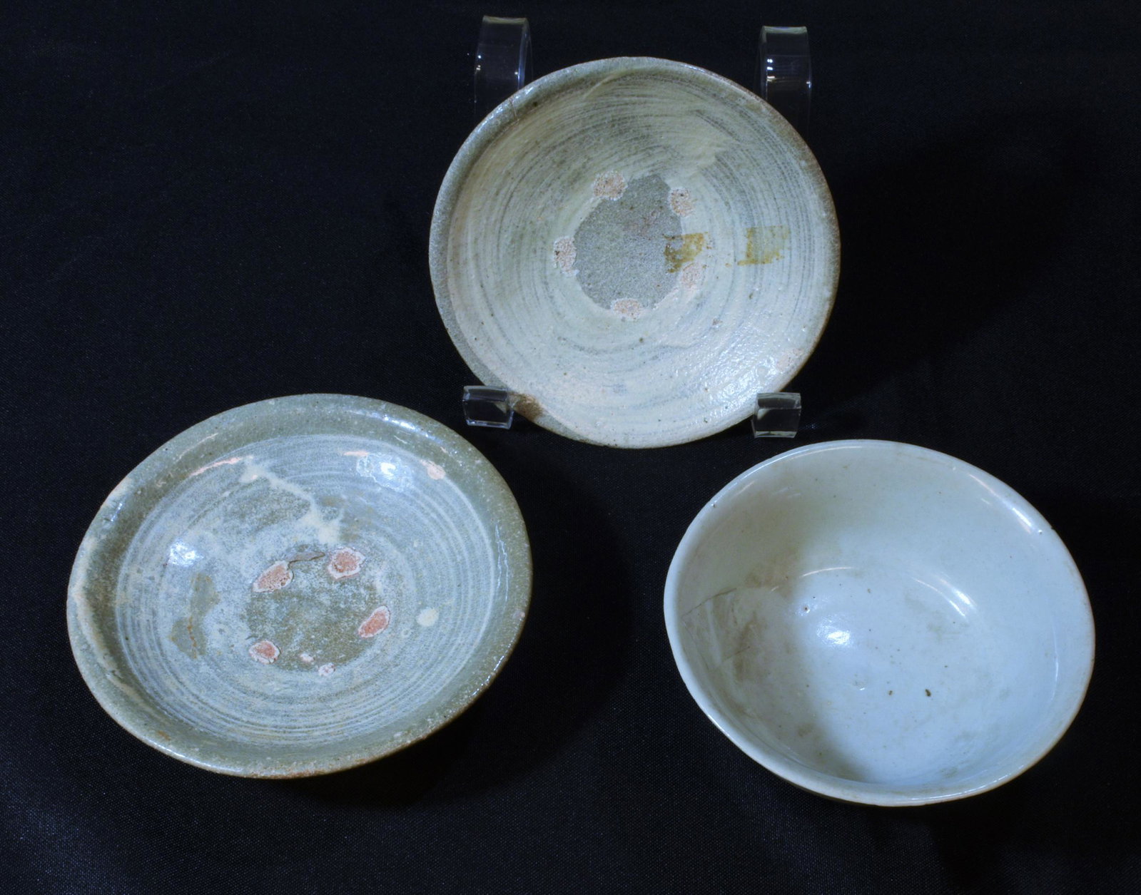 (3) Korean Glazed Dishes,16th - 17th Century: (3) Korean glazed dishes dating to the 16th to 17th century: includes one bowl and two plates. All dishes are earthenware glazed in shades of off-white. Dimensions are: largest: 1 3/8 inches (3.9 cm) 