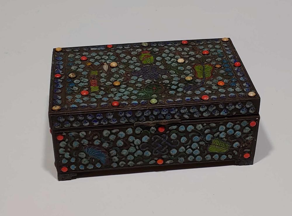 Chinese Enamel Box with Buddhist Treasures, 19th C: Chinese cloisonne enamel box decorated with Buddhist Treasures and lined in wood, 19th century. Cloisonne exterior alternates with applique of coral and/or bone; reference to at least four of the eigh