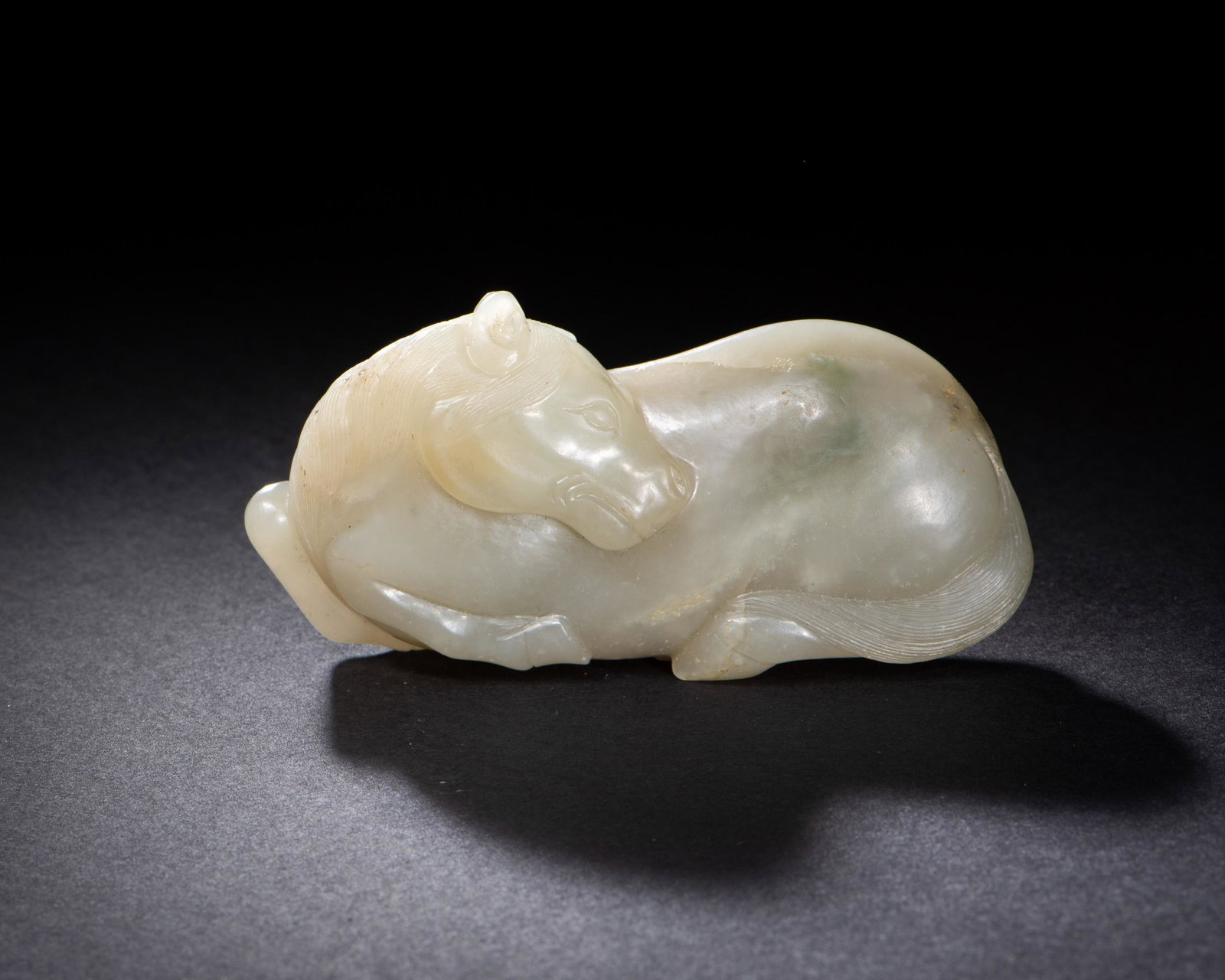 Chinese Jade Carved Horse, Ming: A Chinese jade carving of a horse dating to the Ming dynasty. Dimensions are: 1 1/2 in. tall X 3 in. wide; 3.8 cm tall X 7.6 cm wide. All measurements are approximate. Condition: Miniscule chip to one