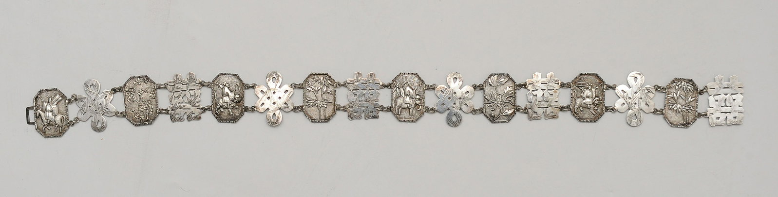 Chinese Metal 16-Link Belt, 19th Century: A soft metal 16-link belt dating from the 19th century. The links include Buddhist knots, double "Xi" happiness characters, and rectangular 8-sided links with bamboo, flowers, and other auspicious emb