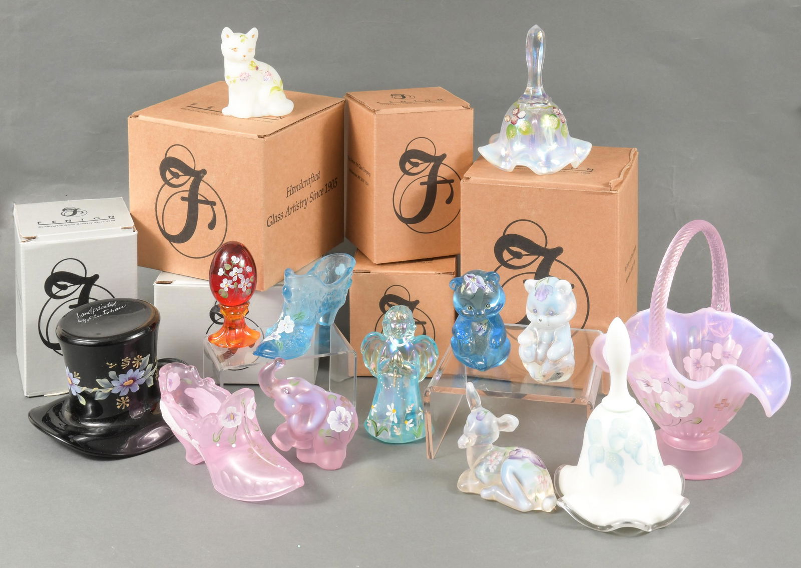 13 Boxed Hand Painted Fenton Glass Figures, Etc: Fenton Art Glass Company (American, founded 1905) glass. Includes a glass bell featuring grapes, a blue angel with a floral design, a clear teddy bear with a floral design, an opalescent cat by D. Wri
