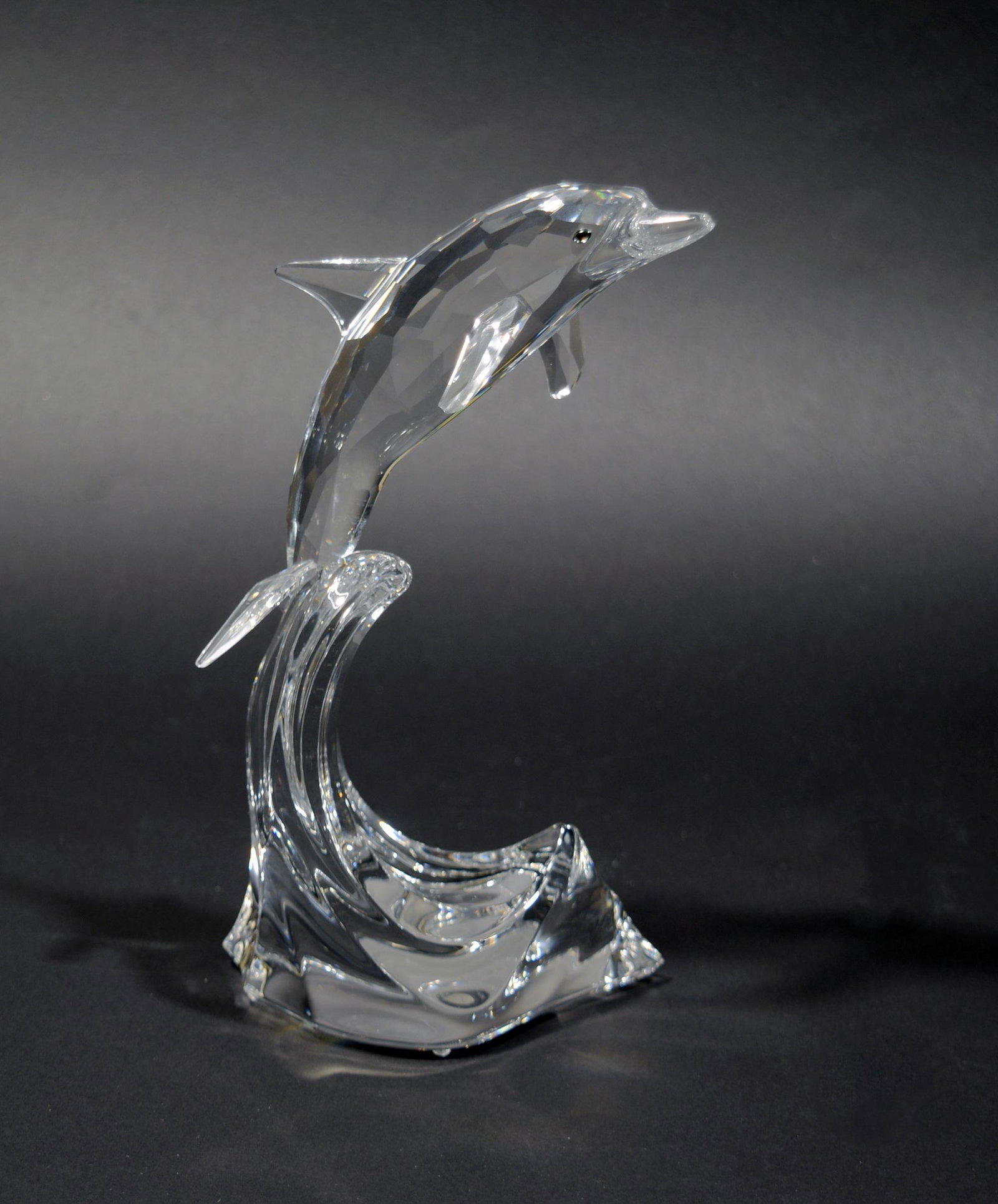 Swarovski, Cased Maxi Dolphin & Swarovski Book: Swarovski (Austrian, founded 1895) crystal. Comes in all of the elaborate original packaging. The figurine features a dolphin mid-jump, and comes with the book "Swarovski, The Magic of Crystal" publis