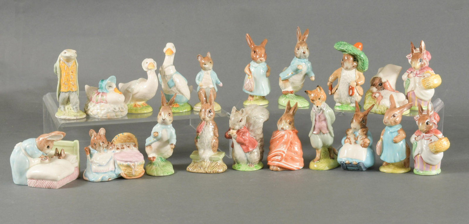 Beswick, 20 Beatrix Potter figures: Beswick Pottery (British, founded 1894.) Includes 20 figures: 2 Peter Rabbit, 2 Mrs. Flopsy Bunny, Sir Isaac Newton, Foxy Whiskered Gentleman, Johnny Town Mouse, Hunca Munca, Mrs. Rabbit and Bunnies, 