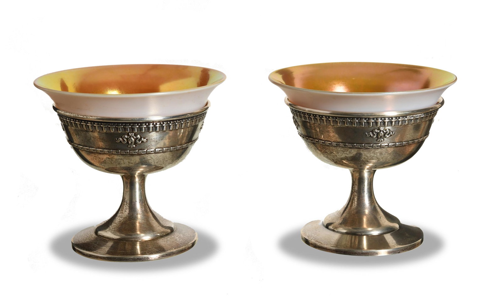 2 Dominick & Haff Sherbets with Steuben Inserts: A pair of Dominick & Haff (American, 1872-1928) sterling bases with Steuben Glass Works (American, founded 1903) gold calcite art glass inserts. The champagne sherbets are marked 'Dominick [and] Haff'