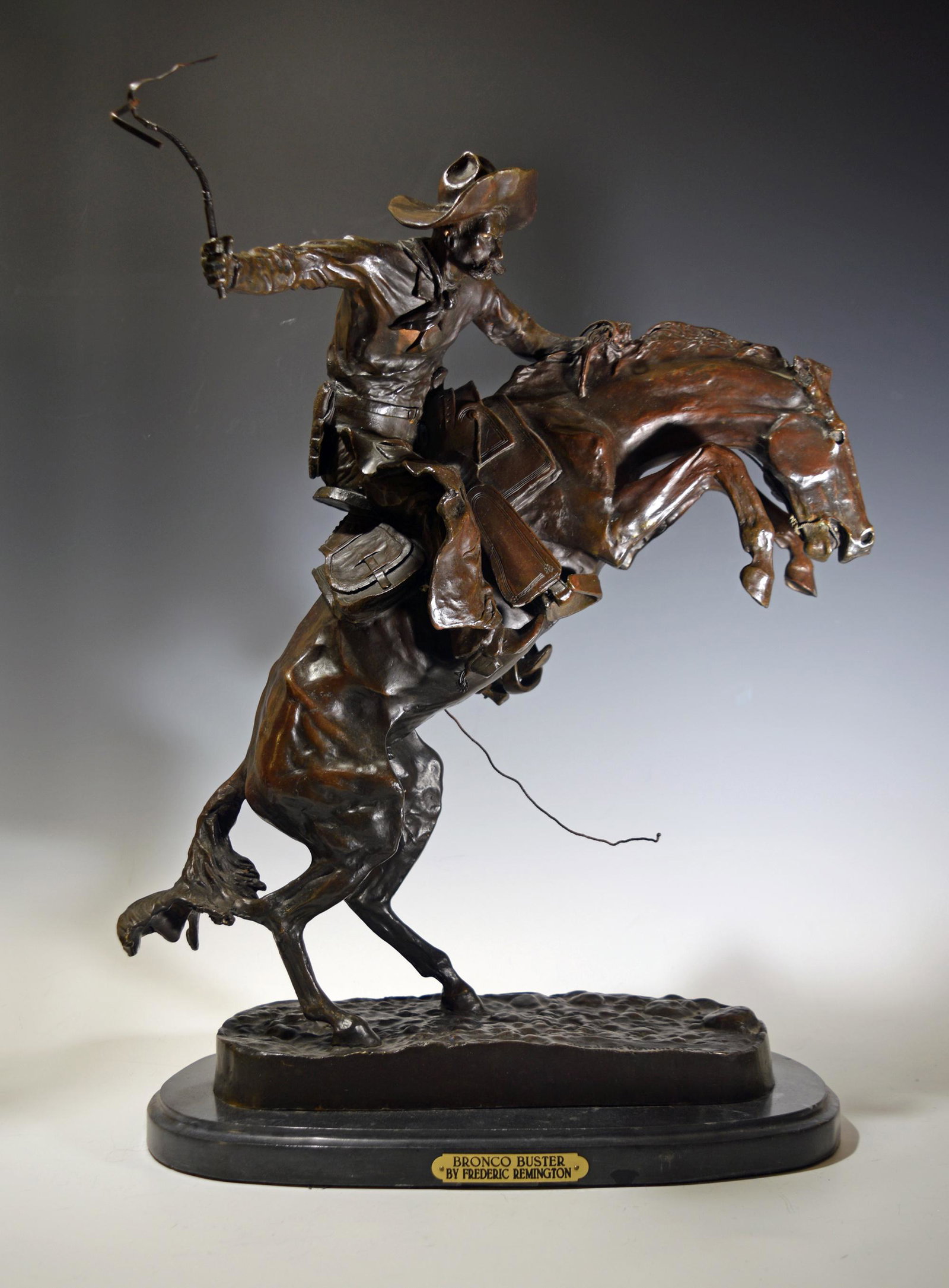 Bronze 'The Bronco Buster' Fredric Remington: Frederic Remington (American, 1861-1909) bronze. A later casting of 'The Bronco Buster' featuring a man on a rearing horse, it is signed 'Frederic Remington.' Dimensions: 23 3/4 inches tall X 17 1/2 i