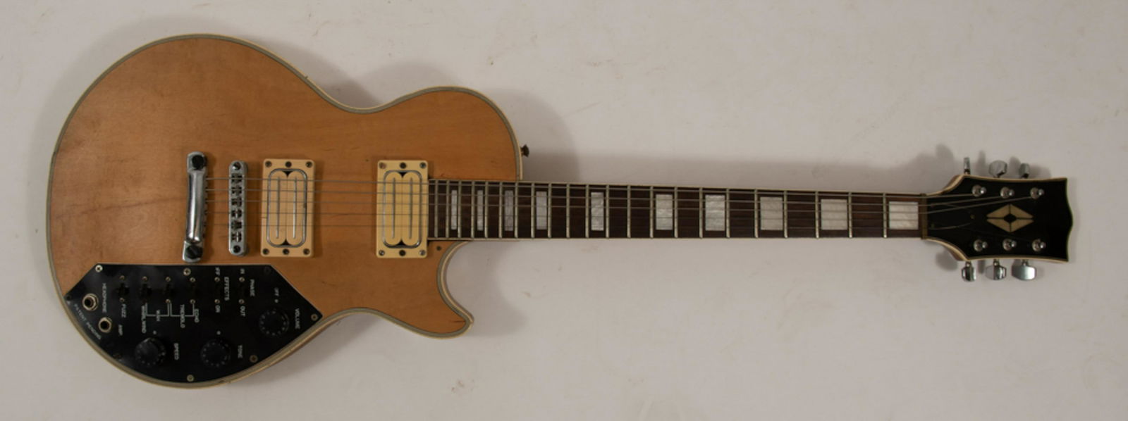 Kay Effector, Guitar with Soft Carrying Case: Vintage 1960s-70s Kay Effector electric guitar, with soft carrying case. Blond wood with an imitation ivory trim and mother of pearl insets in the fret board. Dimensions: 39 1/2 inches tall X 13 1/8 i