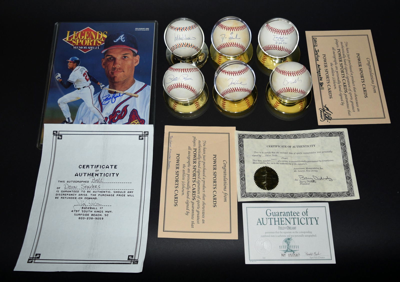 6 Autographed Baseballs & Magazine: Baseball memorabilia including: a David Justice Ball & magazine with certificates, Deion Sanders signed ball, Pete Rose signed ball, Tom Glavine signed ball with certificates. The Mike Mussina signed