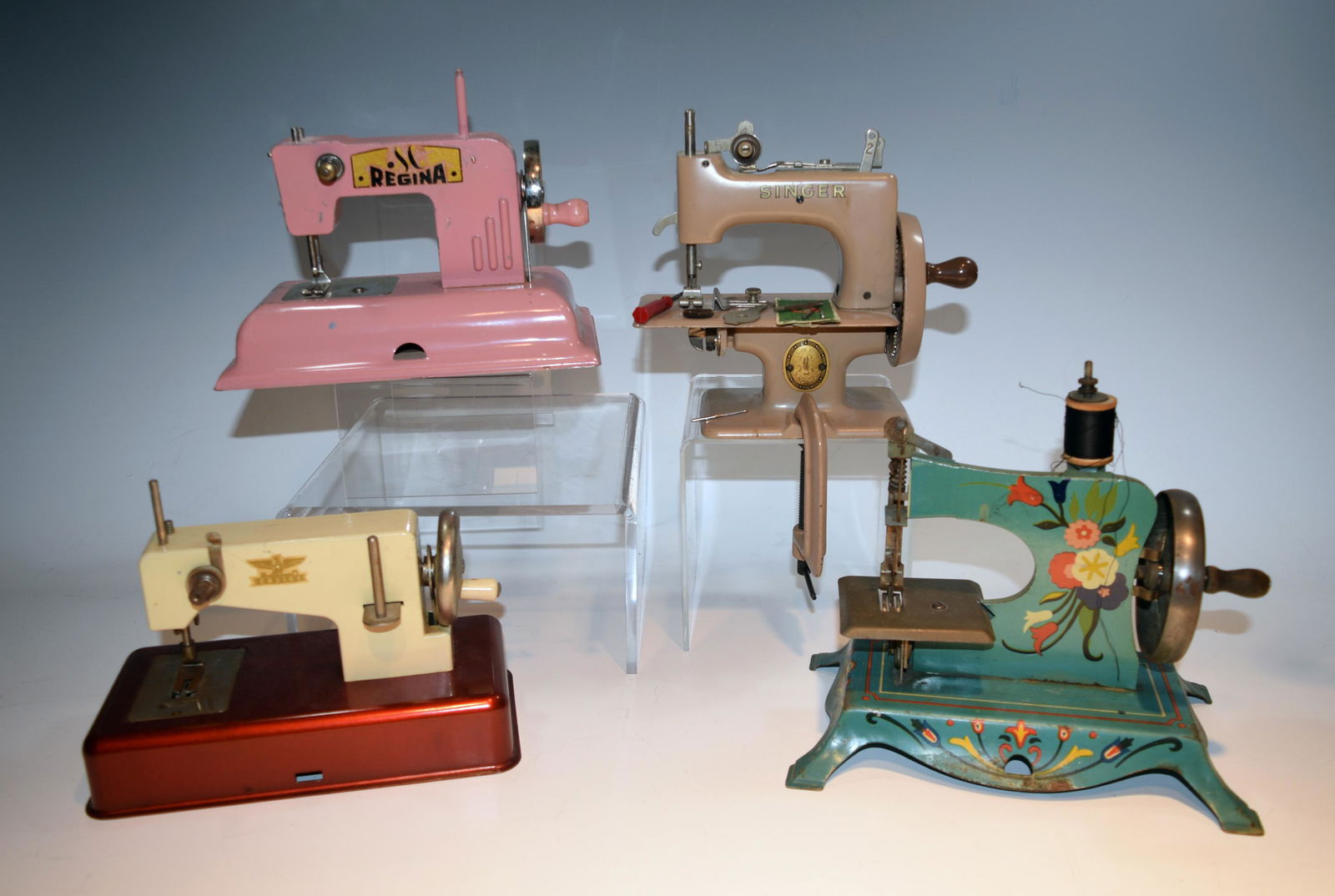 4 Toy Sewing Machines, Inc. Singer: A group of 4 toy sewing machines. Includes 1 by Casige, made in Western Germany; another by Regina, made in the US Zone of Berlin; another by Singer, made in Great Britain with additional accessories;