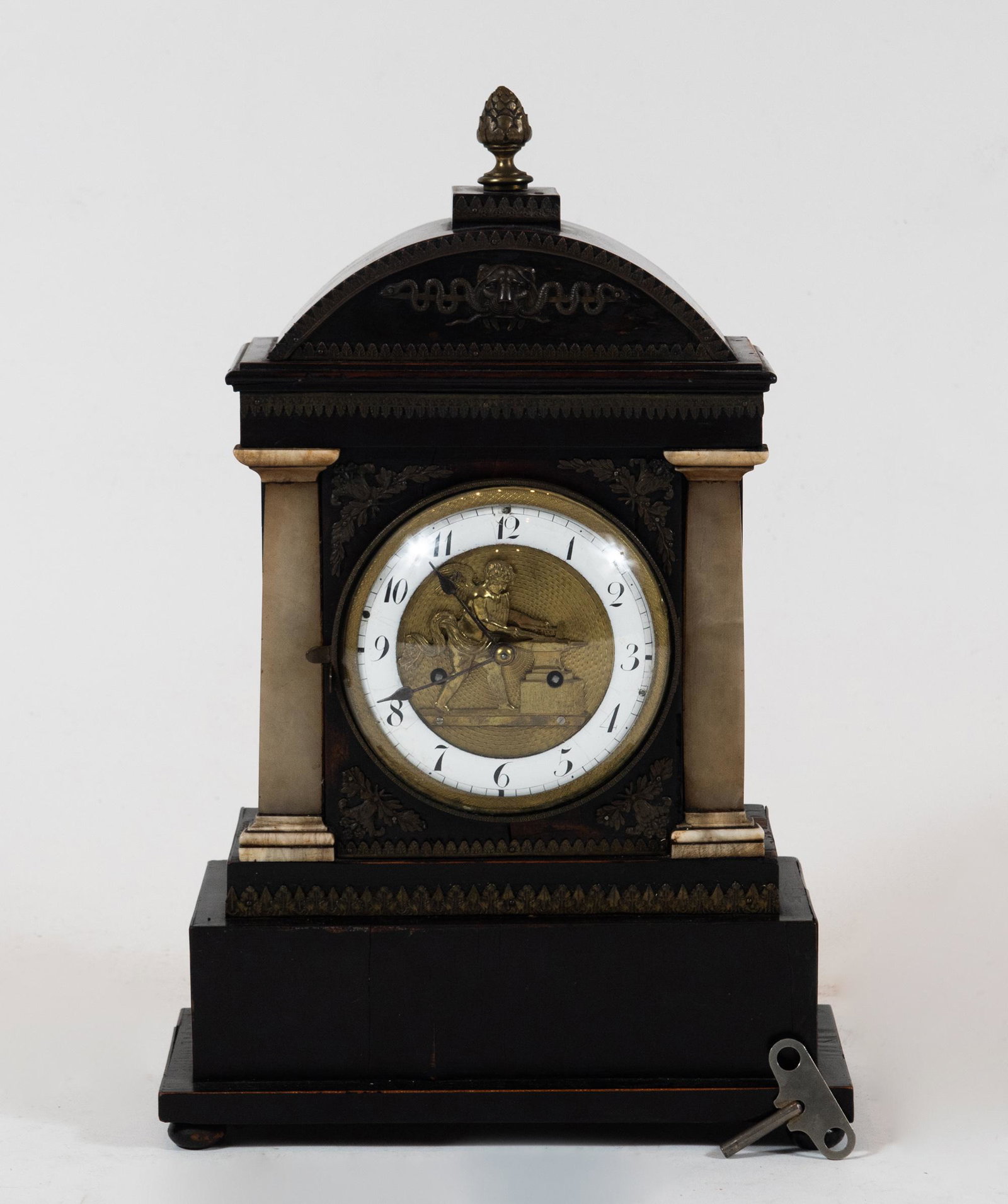 Austrian Biedermeier Automaton Clock with Cupid: Ebonized wood case with onyx columns and bronze mounts including a lion holding a snake wrapped around a staff. The hinged glass dome face opens to reveal a painted enamel dial with Arabic numerals. T