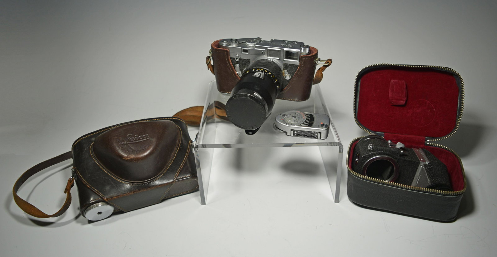 Leica M3 with Leitz Wetzlar 1:4/135mm Lens: M3 single stroke, serial No. 1056835 produced in 1962. Also includes a Leica MC light meter, leather Leica camera case and a Japanese made Visoflex SLR adapter. Dimensions: camera body, 5 1/2 inches l