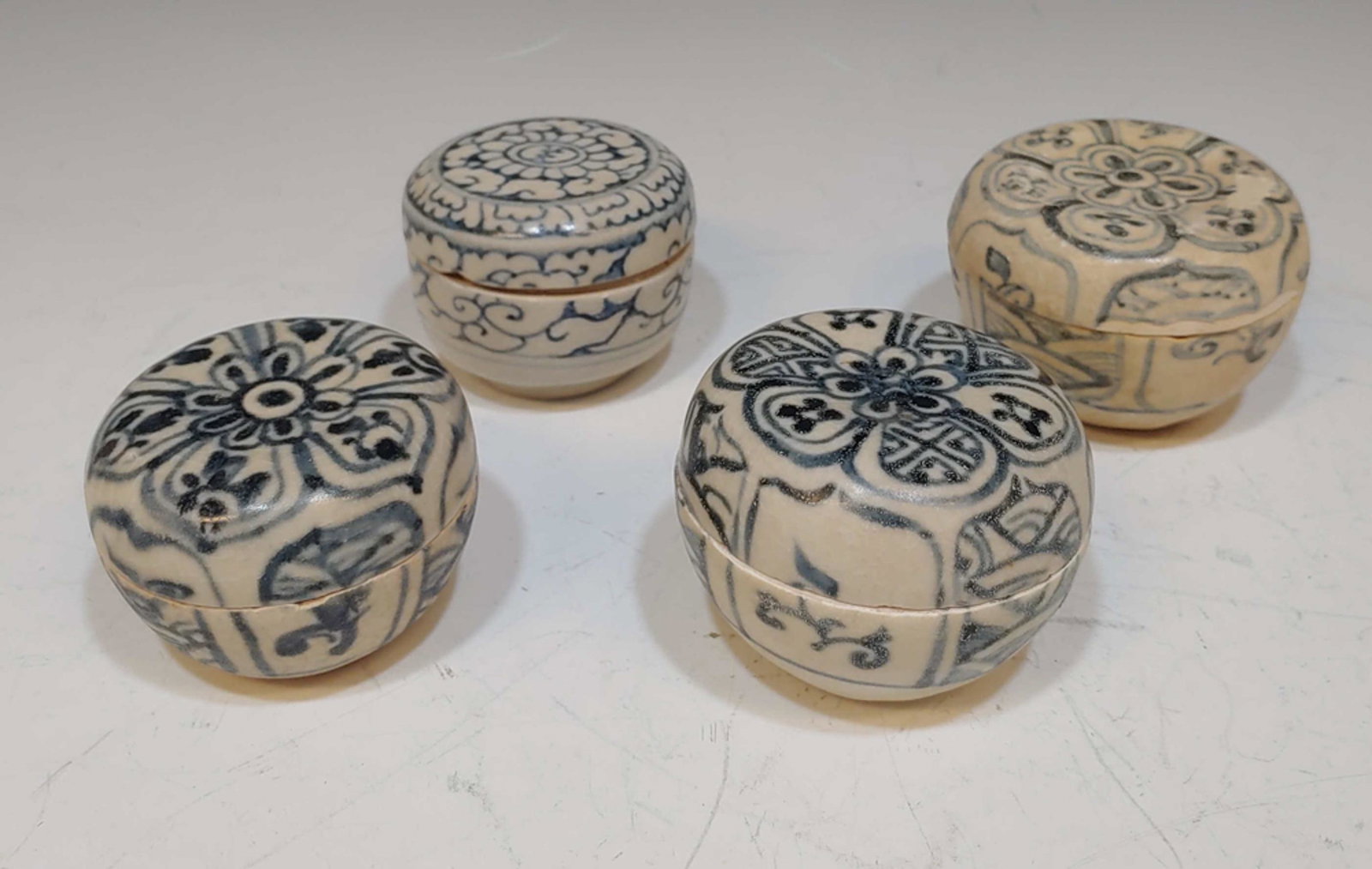 4 Vietnamese Shipwreck Jarlets: 4 Vietnamese shipwreck lidded jarlets. All jarlets are blue and white with lids and feature a flower design. Dimensions of the largest: 2 inches tall X 3 inches diameter; 5.1 cm tall X 7.6 cm diameter