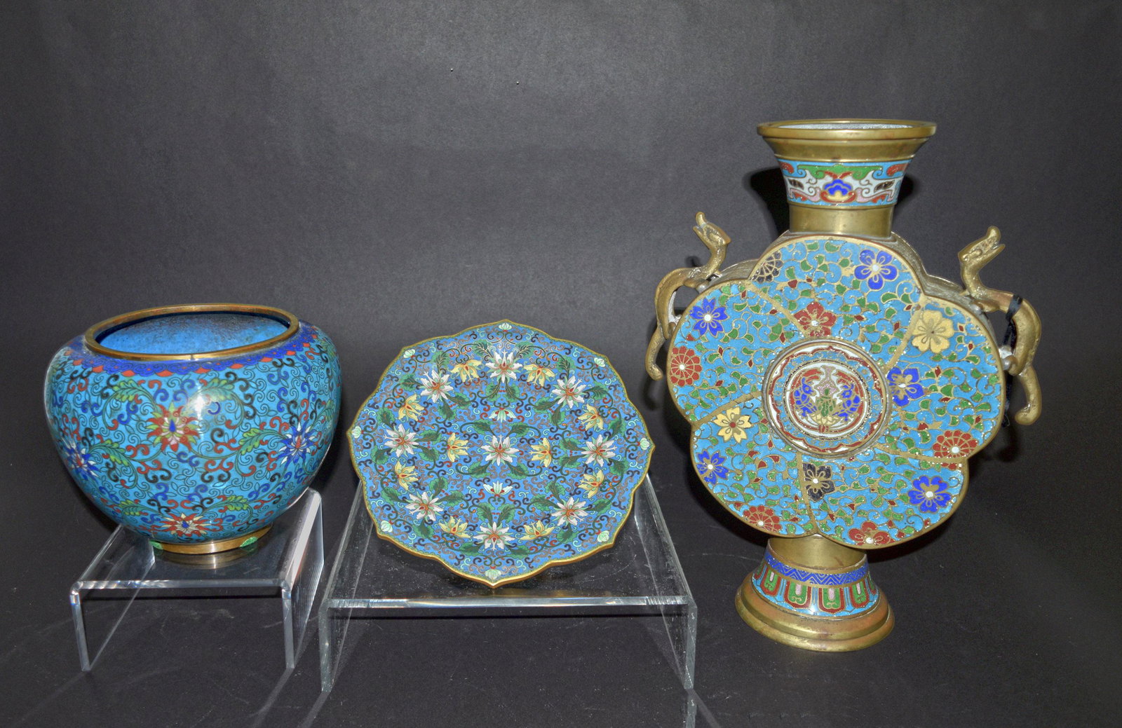 3 Chinese Cloisonne Items: A group of cloisonne including a large flask, a pot and a plate. The pot and plate both feature blue ground with flower decoration. The flask features blue ground with bird and flower decoration as we