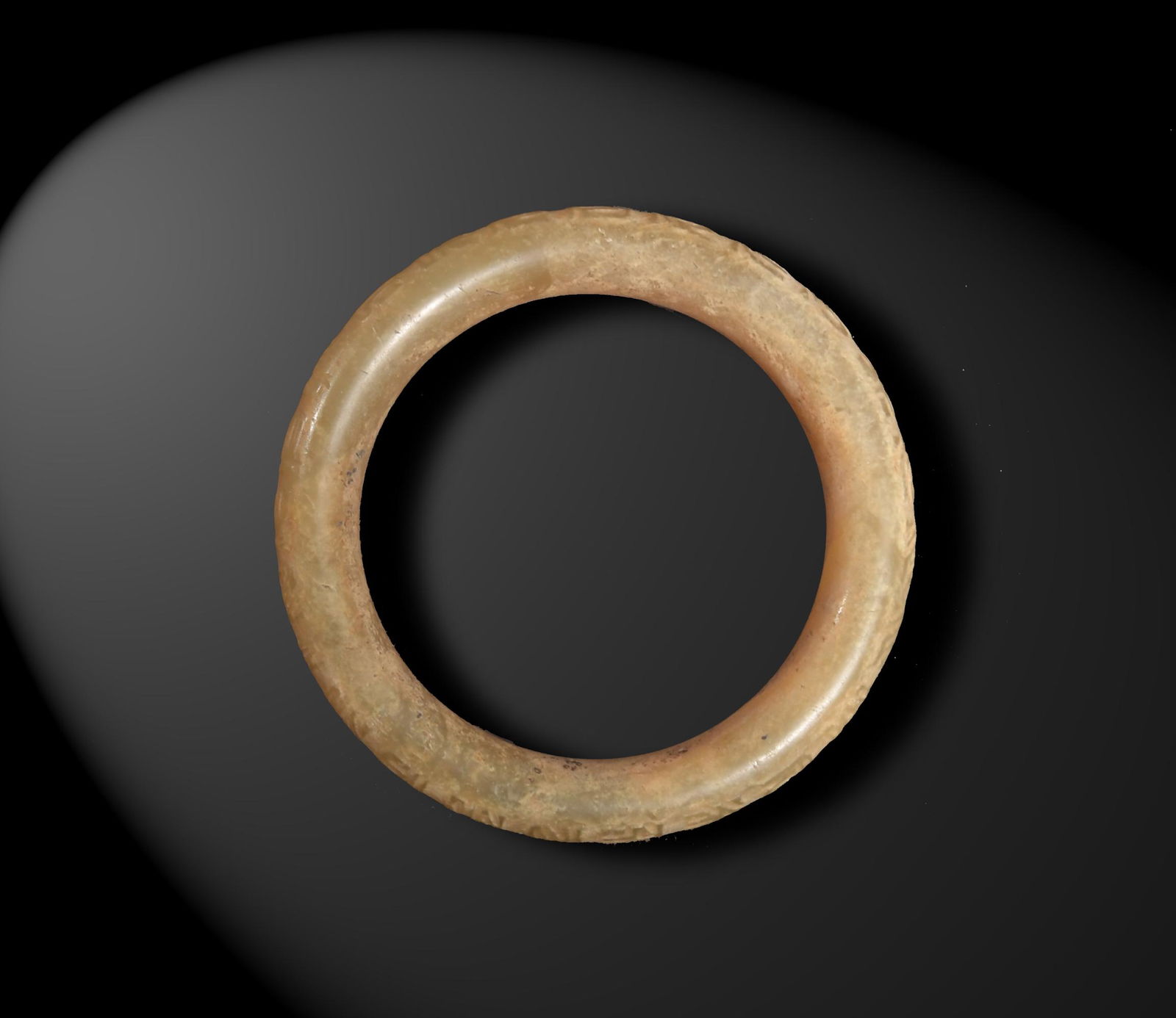 Chinese Jade Bracelet, Ming Dynasty or Earlier: A Chinese yellow jade bangle dating from the Ming dynasty or earlier. The bangle features two bands of carved characters. Dimensions are: 3 1/8 inches diameter X 3/8 inch thick; 7.9 cm tall X .9 cm th