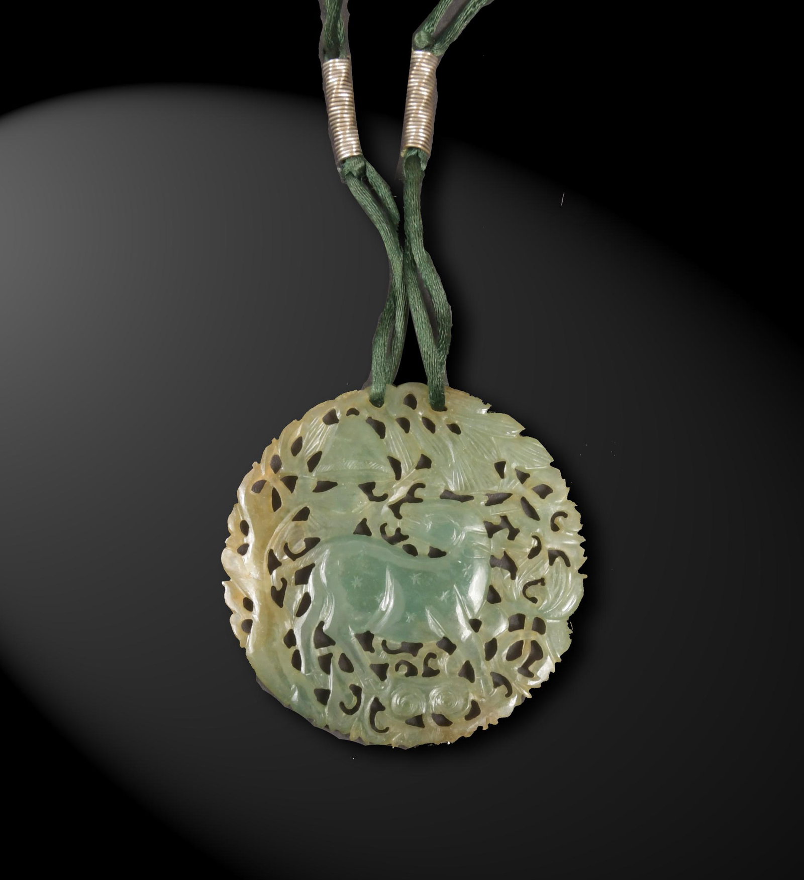 Chinese Jadeite Pierced Plaque, 19th Century: A Chinese pierced jadeite circular plaque dating from the 19th century. The plaque features a deer with lingzhi. Dimensions are: 2 3/8 inches diameter; 6.1 cm diameter. All measurements are approximat