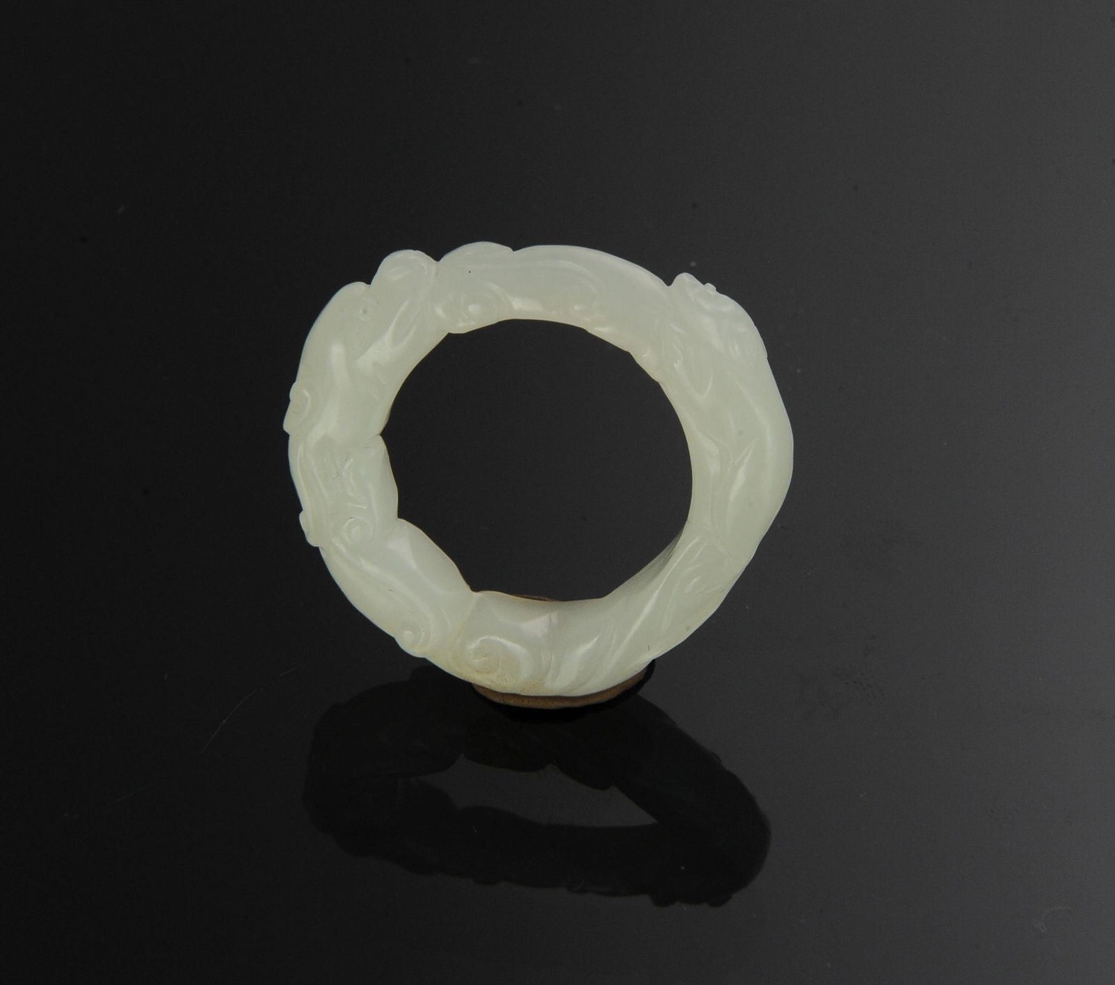 Chinese White Jade Dragon Ring, 18th Century: A Chinese white jade ring dating from the 18th century. The ring features a dragon and a rat. Dimensions are: 1/4 inch tall X 1 1/4 inches wide; .6 cm tall X 3.2 cm wide. Ring size- 10 1/2. All measur