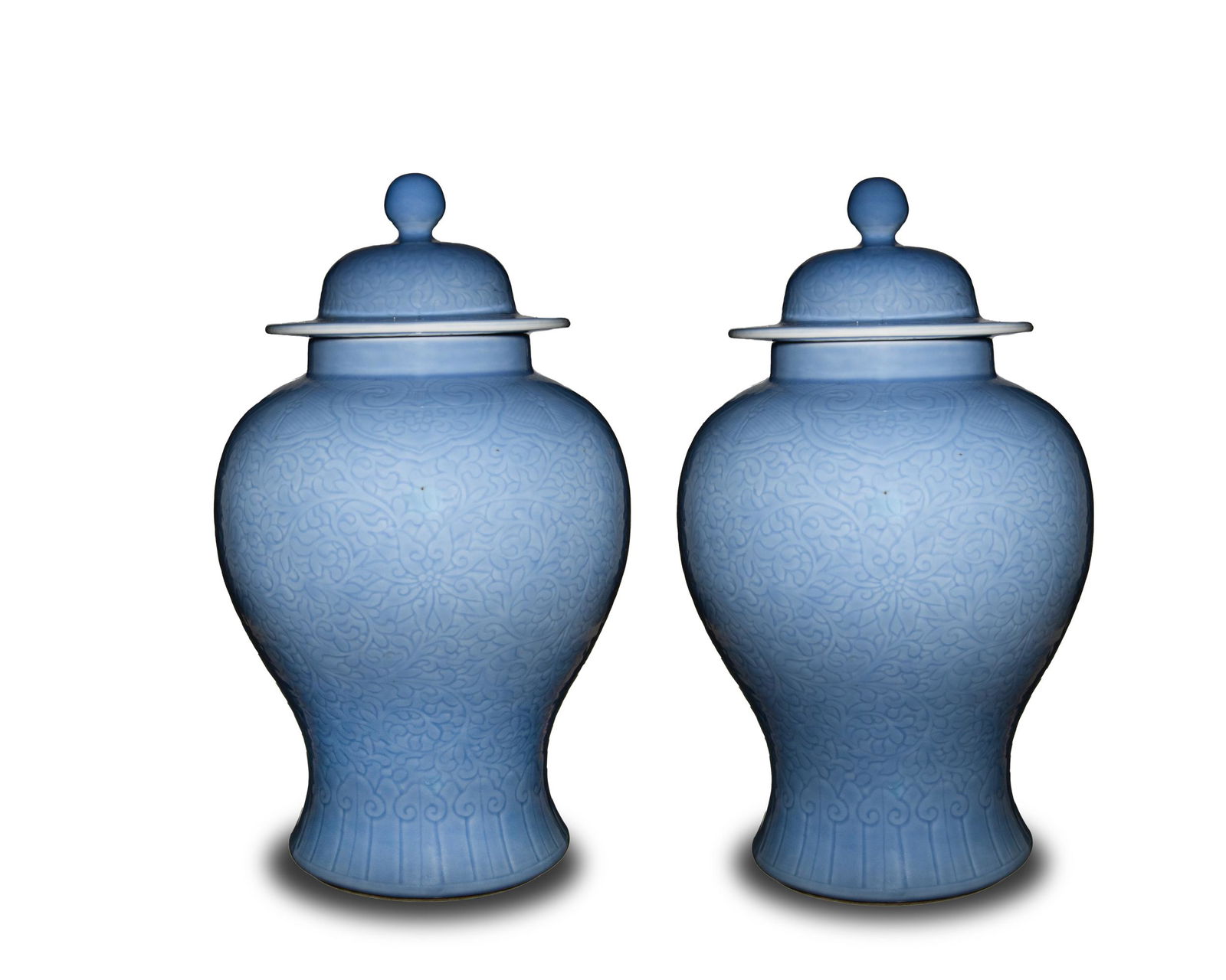 Pair of Chinese Blue General Jars, Republic: A pair of Chinese blue glazed general jars with lids and dating from the Republic period. Both jars are etched with lotus tracery around the body and a ruyi border at the top and bottom. The lids feat