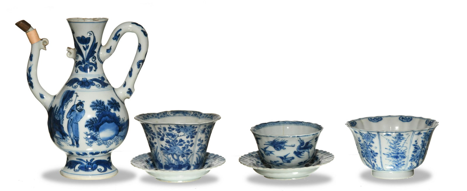Chinese Blue-and-White Tea Set, Kangxi: A blue-and-white Chinese tea set dating from the Kangxi period. Includes a teapot featuring a man and an elephant in a landscape, 2 cups depicting flowers and another depicting a phoenix among other b